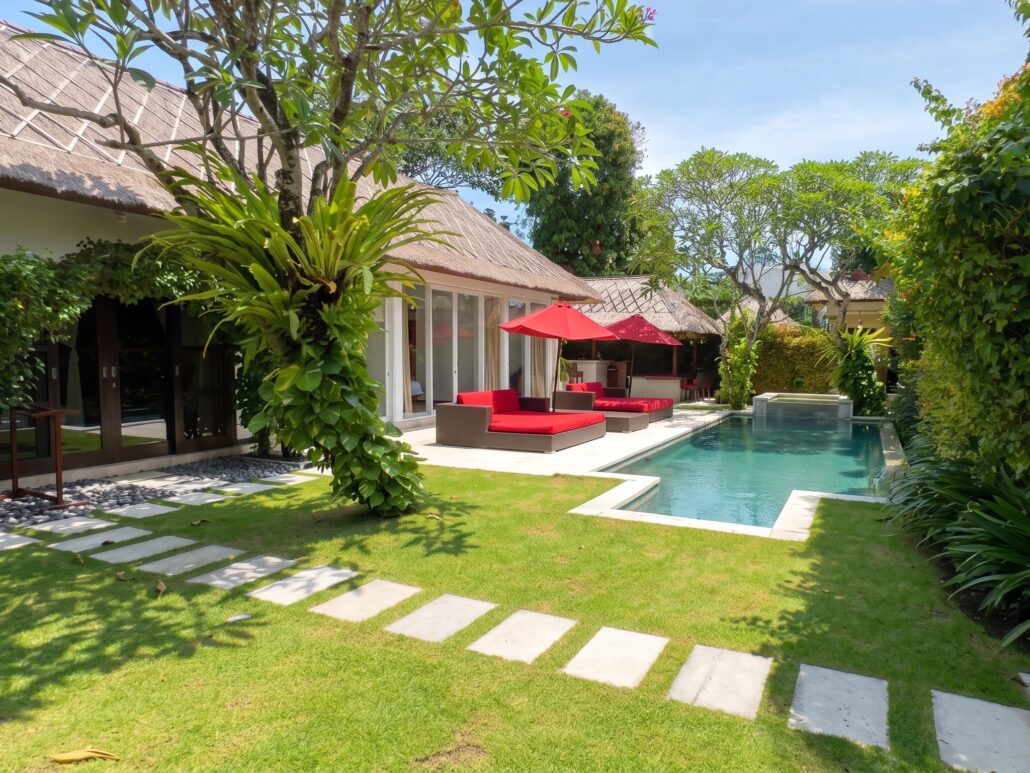 Spacious private swimming pool with sun loungers in the tropical garden at Villa Jaclan Seminyak