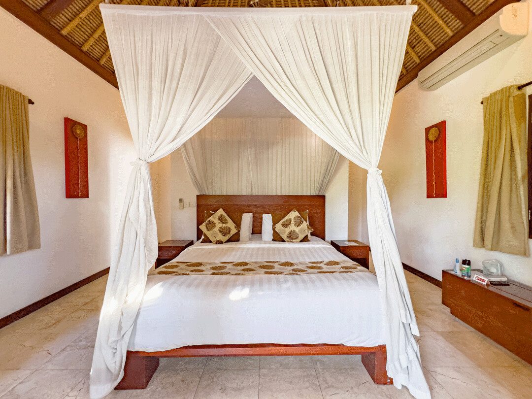 Serene second bedroom at Villa Jaclan Seminyak by Villa Bugis villa Seminyak with premium king-size bedding and a direct view overlooking the pool area.