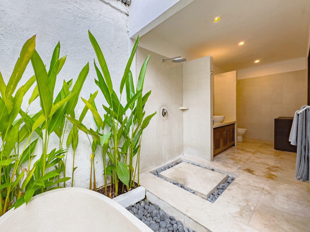 Private guest bathroom with a soaking bathtub for bedroom 3 at Villa Jaclan Seminyak by Villa Bugis, offering standard luxury features for a premium villa Seminyak.