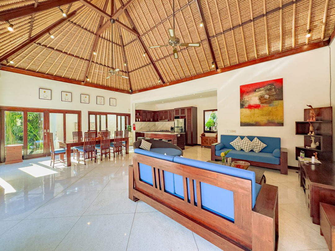 Elegant wooden furnishings and ambient lighting setup in the living room at Villa Kebun Seminyak by Villa Bugis villa Seminyak.