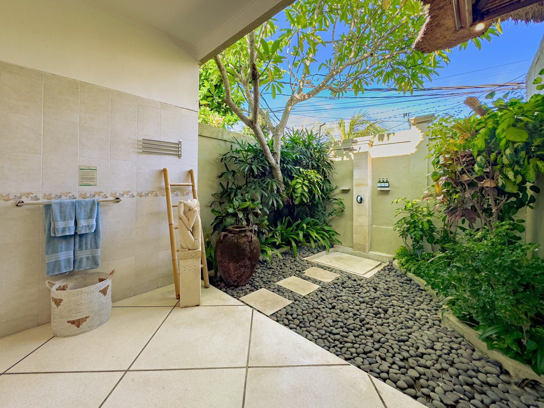 Ensuite open-air tropical bathroom for bedroom 3 at Villa Kebun Seminyak by Villa Bugis, equipped with a modern refreshing shower in this villa Seminyak.