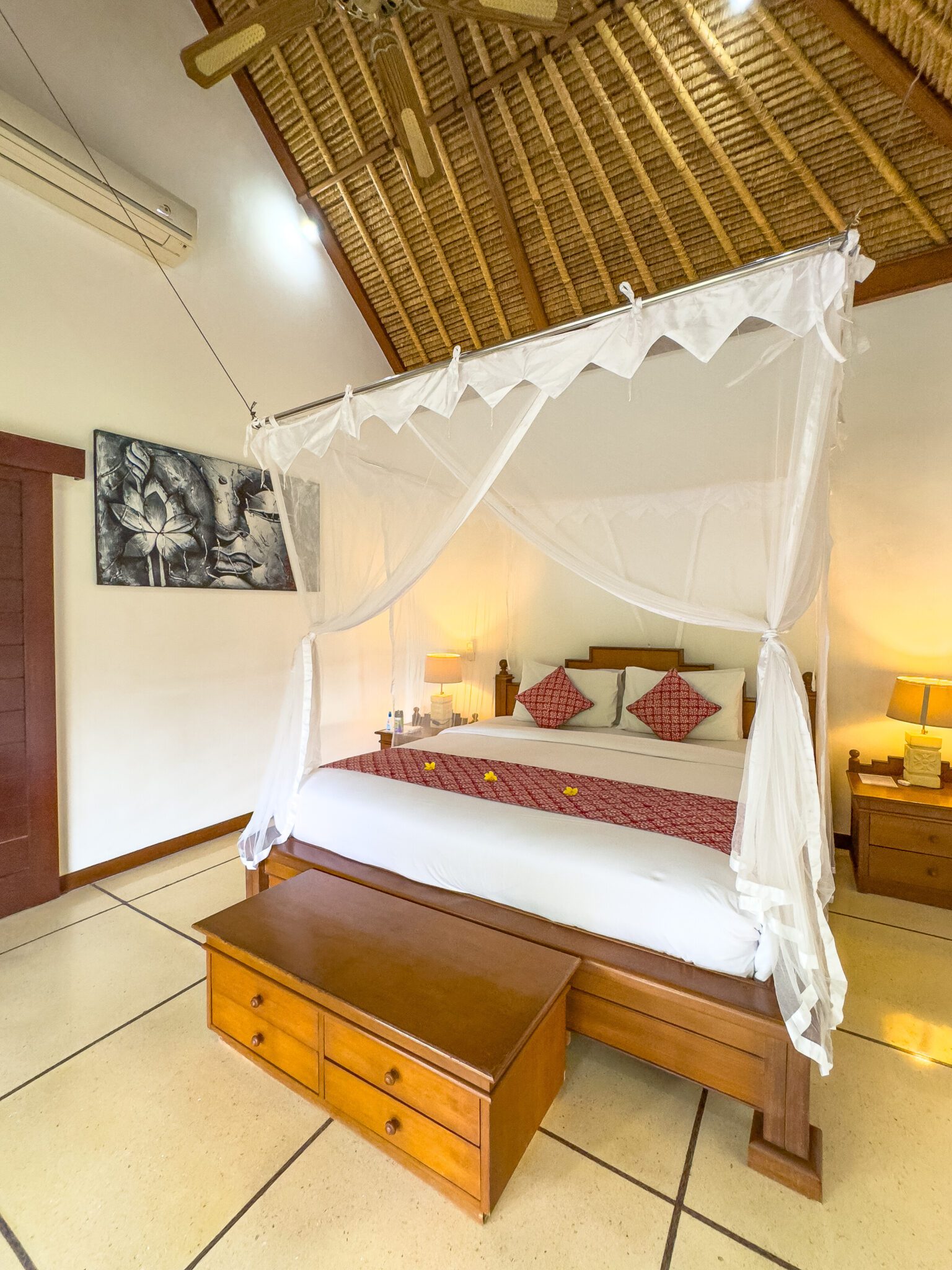 Spacious interior layout of bedroom 1 at Villa Krisna Seminyak by Villa Bugis Seminyak villas, complete with air conditioning and elegant wooden furnishings.