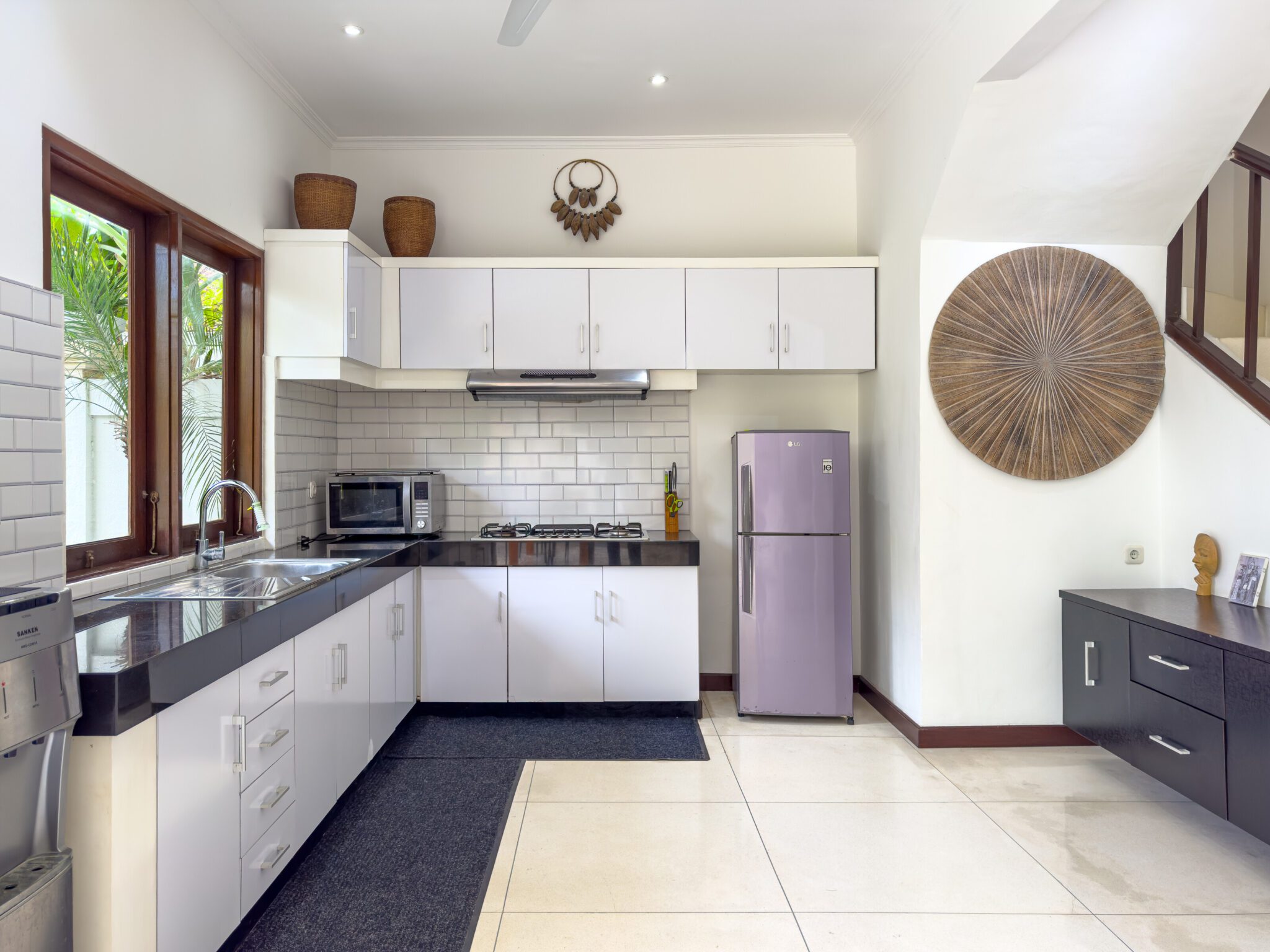 Modern open-concept kitchen fully equipped with high-quality appliances at Villa Krisna Seminyak by Villa Bugis villa Seminyak.