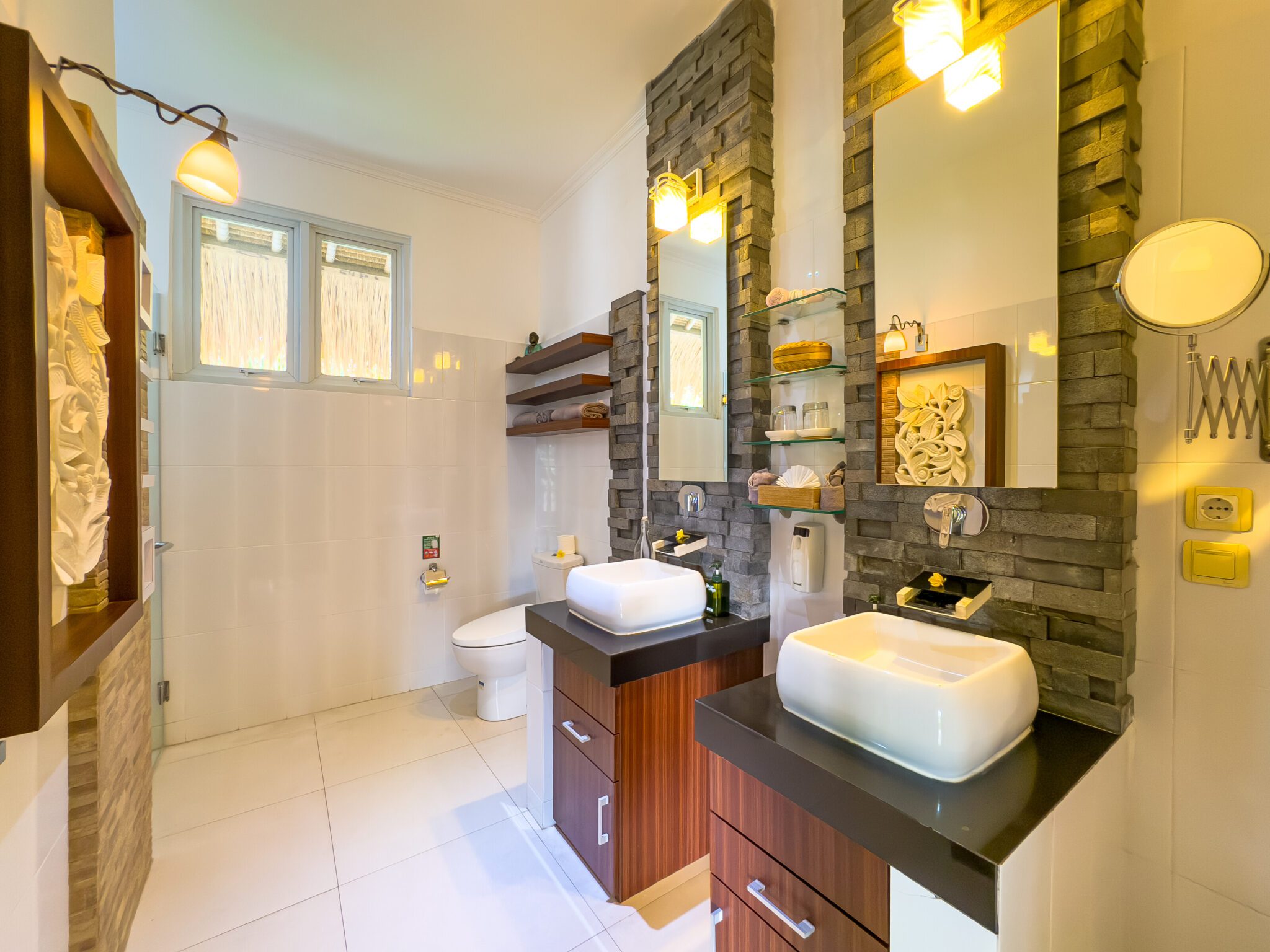 Clean modern vanity, stone basin, and refreshing shower area in the master bathroom at Villa Krisna Seminyak by Villa Bugis Seminyak villas.