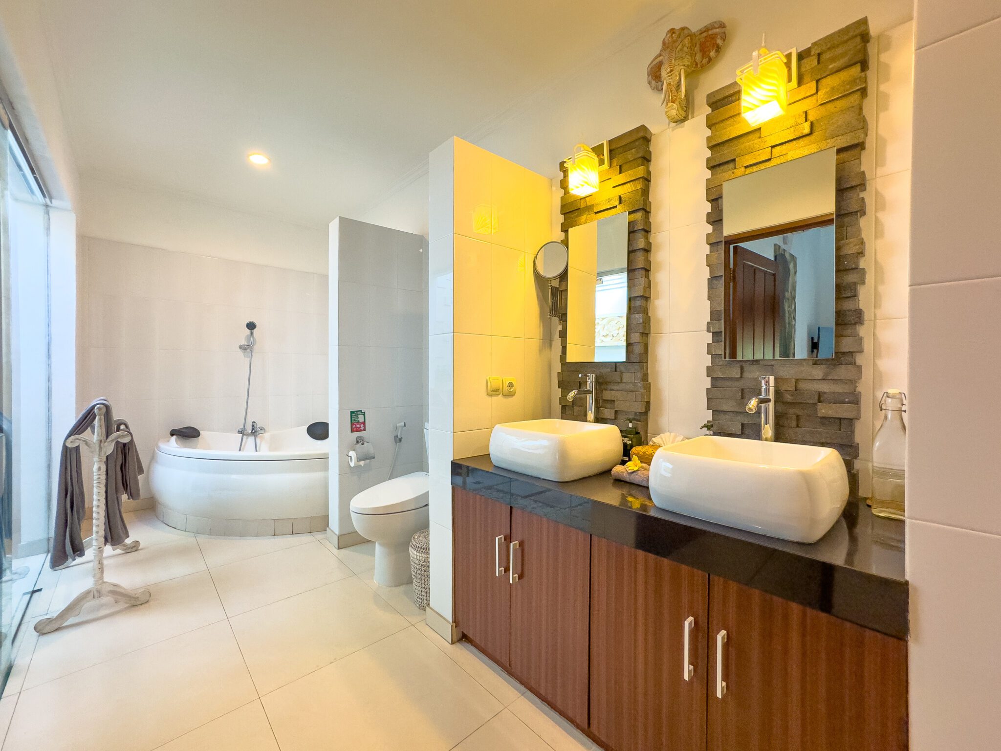 Private ensuite bathroom with a soaking bathtub and modern fixtures for bedroom 2 at Villa Krisna Seminyak by Villa Bugis Seminyak villas.