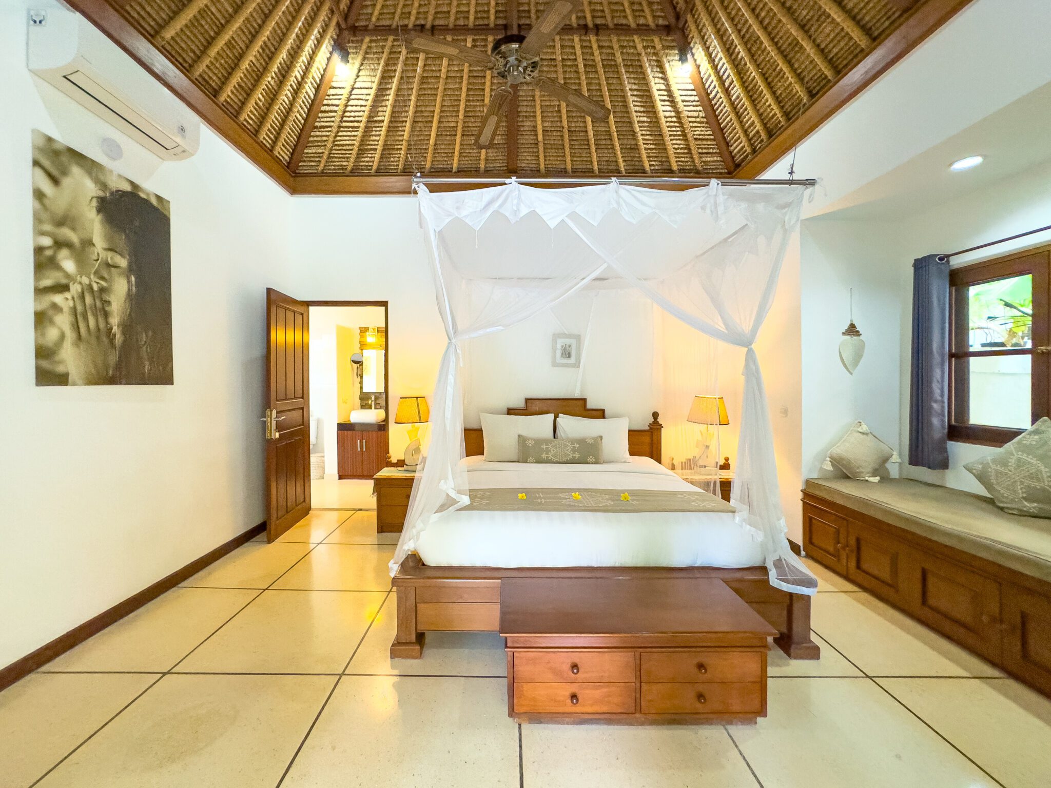 Cozy second bedroom with a comfortable king-size bed and warm lighting at Villa Krisna Seminyak by Villa Bugis, ideal for Seminyak villas guests.