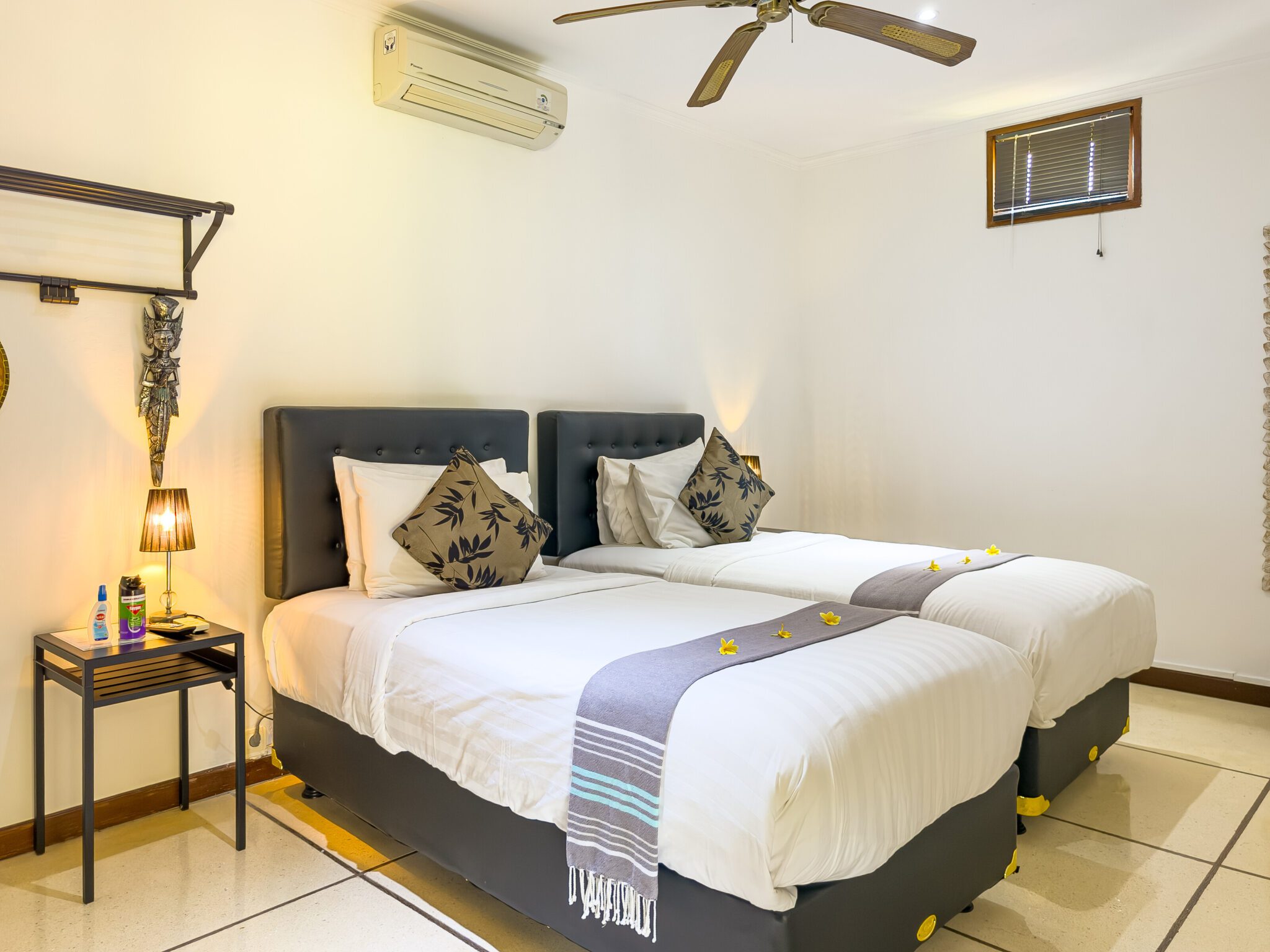 Airy twin bedroom interior setup at Villa Krisna Seminyak by Villa Bugis Seminyak villas, equipped with air conditioning and comfortable double single beds.