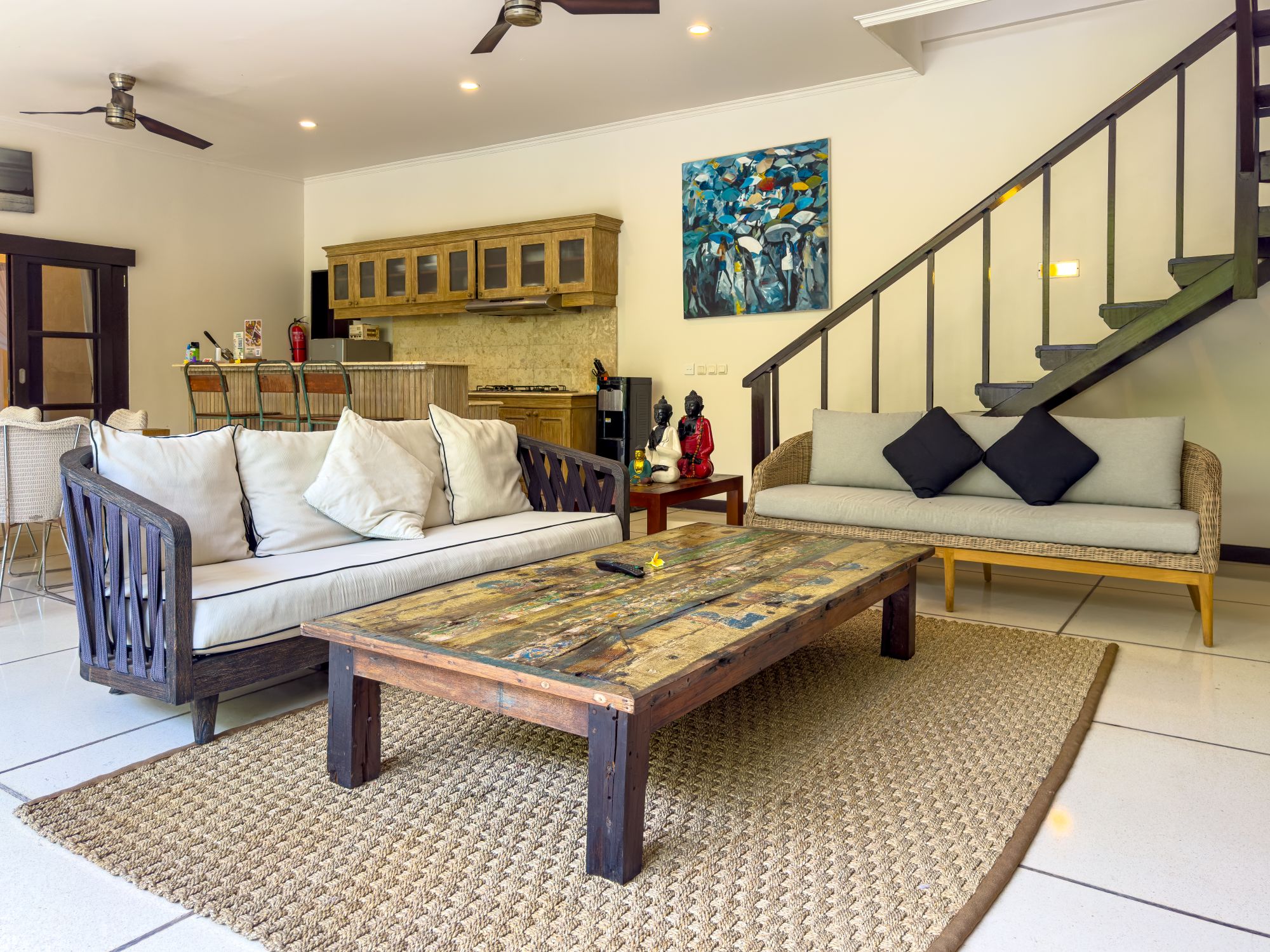 Open-air living room pavilion with plush sofa seating facing the private pool at Villa Nakula Seminyak by Villa Bugis villa Seminyak.