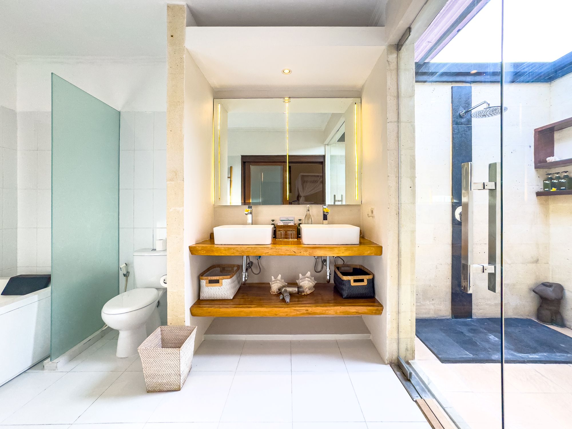 Tropical semi-outdoor ensuite bathroom attached to bedroom 1 at Villa Nakula Seminyak by Villa Bugis, offering a unique villa Seminyak experience.