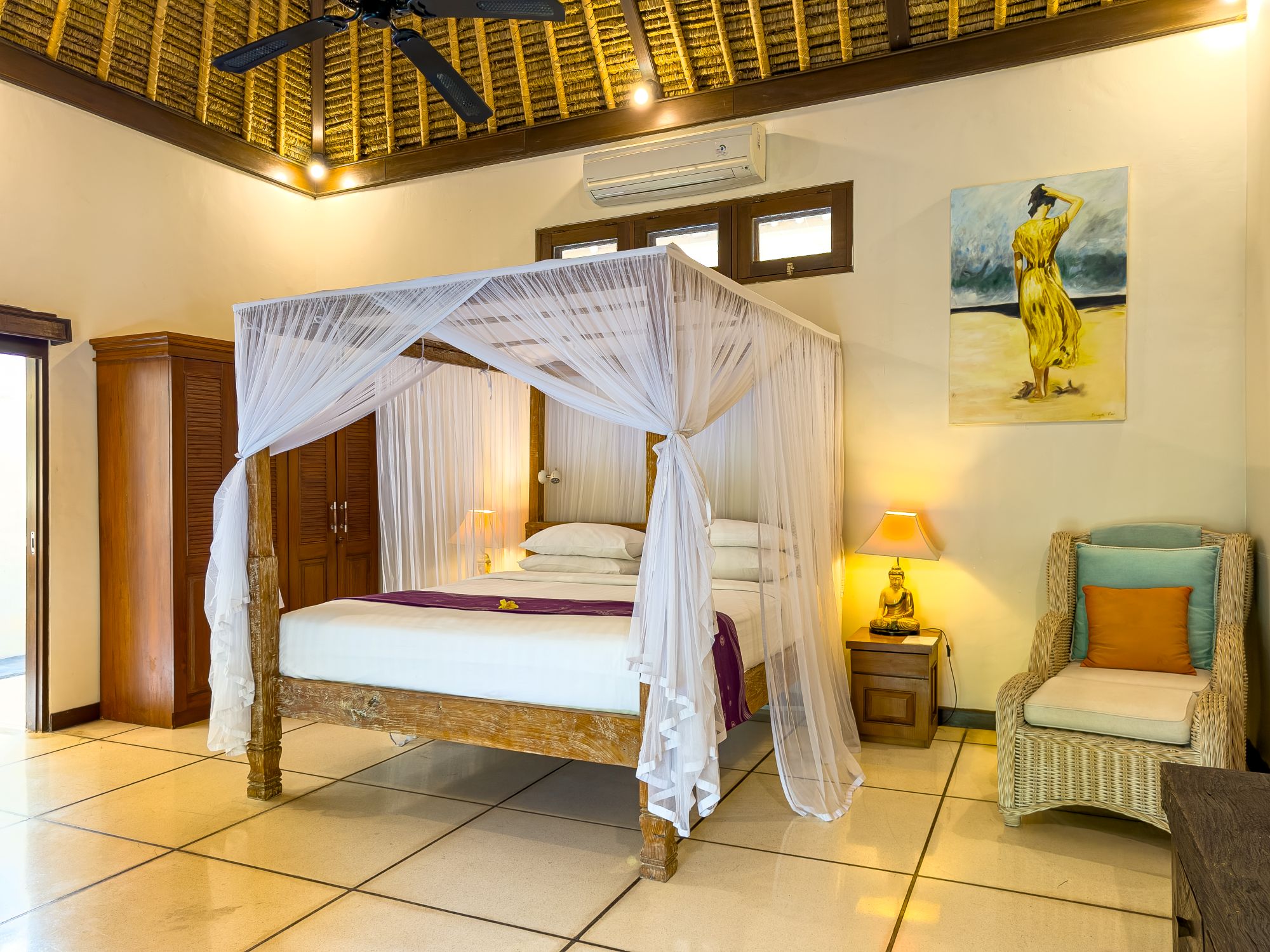 Spacious interior layout of bedroom 1 at Villa Nakula Seminyak by Villa Bugis Seminyak villas, complete with air conditioning and elegant wooden furnishings.