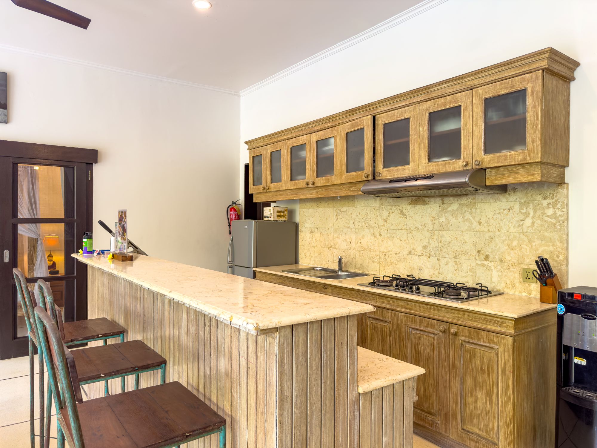 Modern open-concept kitchen fully equipped with high-quality appliances at Villa Nakula Seminyak by Villa Bugis villa Seminyak.