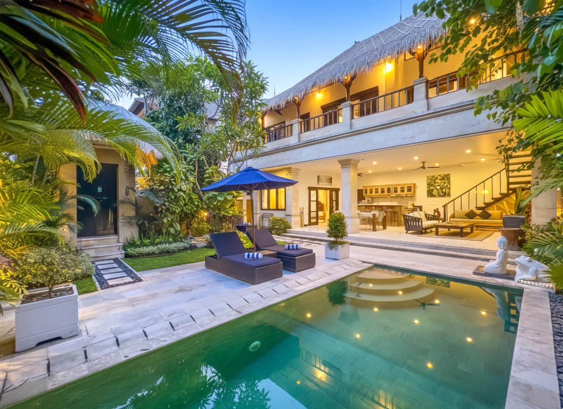 Serene evening ambiance with warm lighting reflecting on the private pool at Villa Nakula Seminyak by Villa Bugis villa Seminyak.