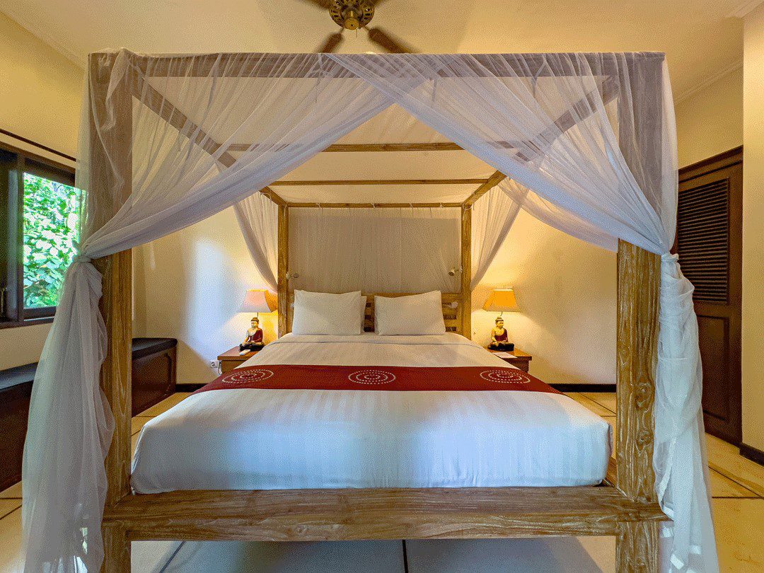 Cozy second bedroom with a comfortable king-size bed and warm lighting at Villa Nakula Seminyak by Villa Bugis, ideal for Seminyak villas guests.