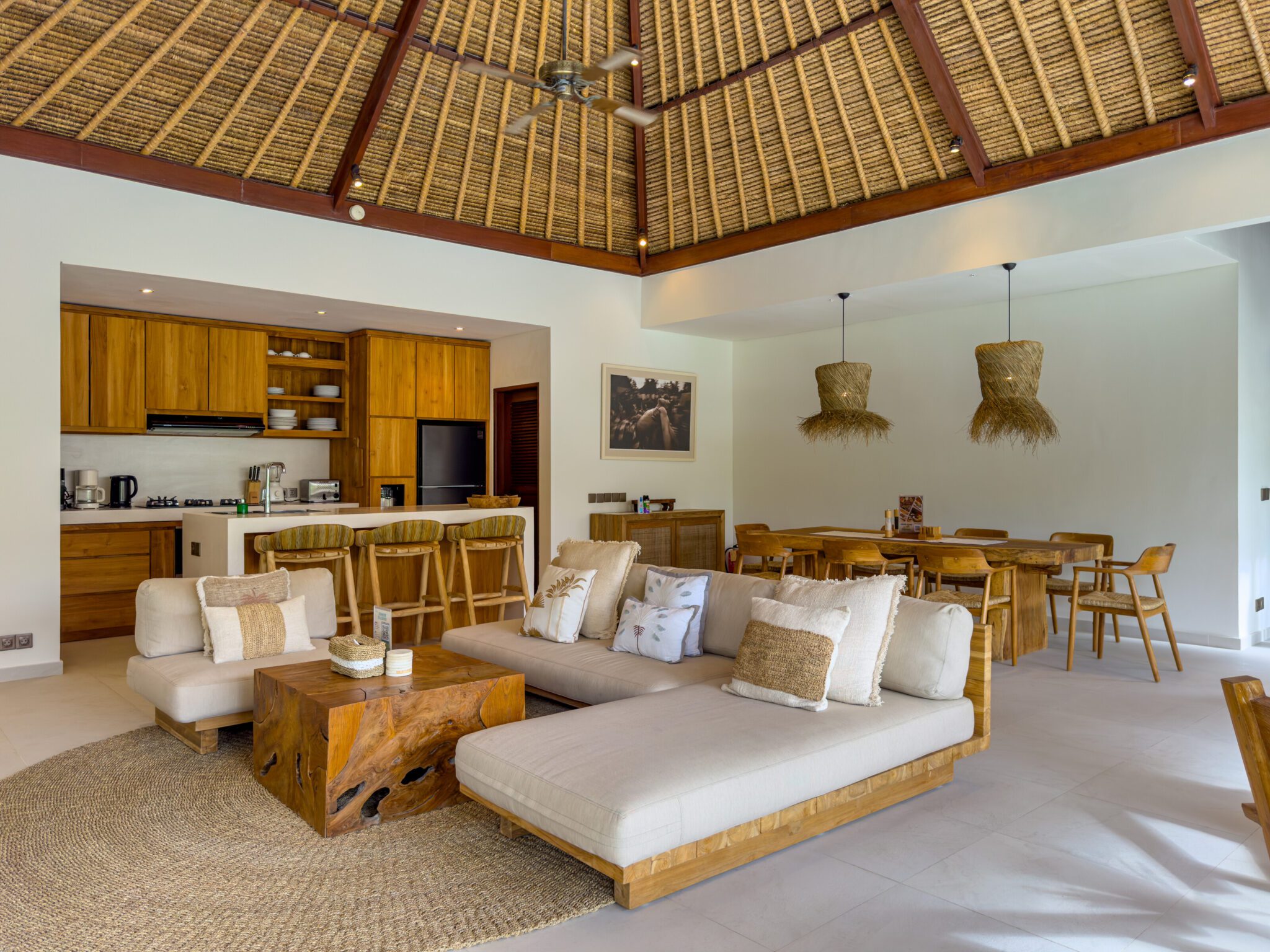Elegant wooden decor and cozy seating arrangement in the living pavilion beside the open kitchen at Villa Olive Seminyak by Villa Bugis Seminyak villas.