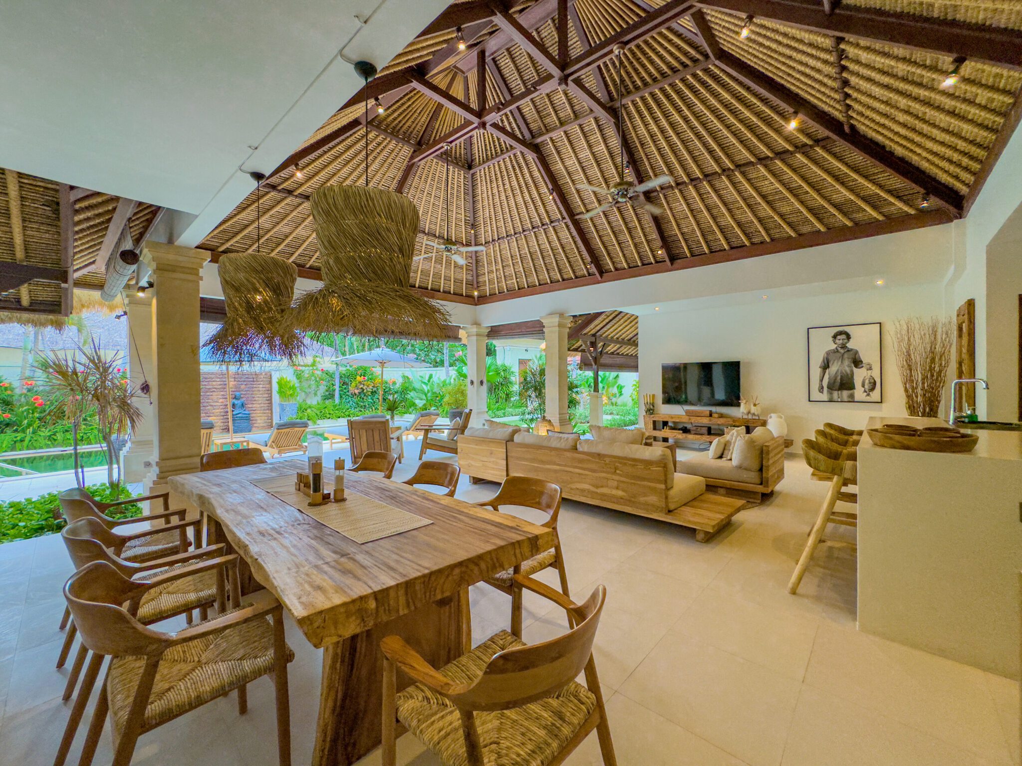 Tropical indoor-outdoor living concept overlooking the pool and garden at Villa Olive Seminyak by Villa Bugis Seminyak villas.
