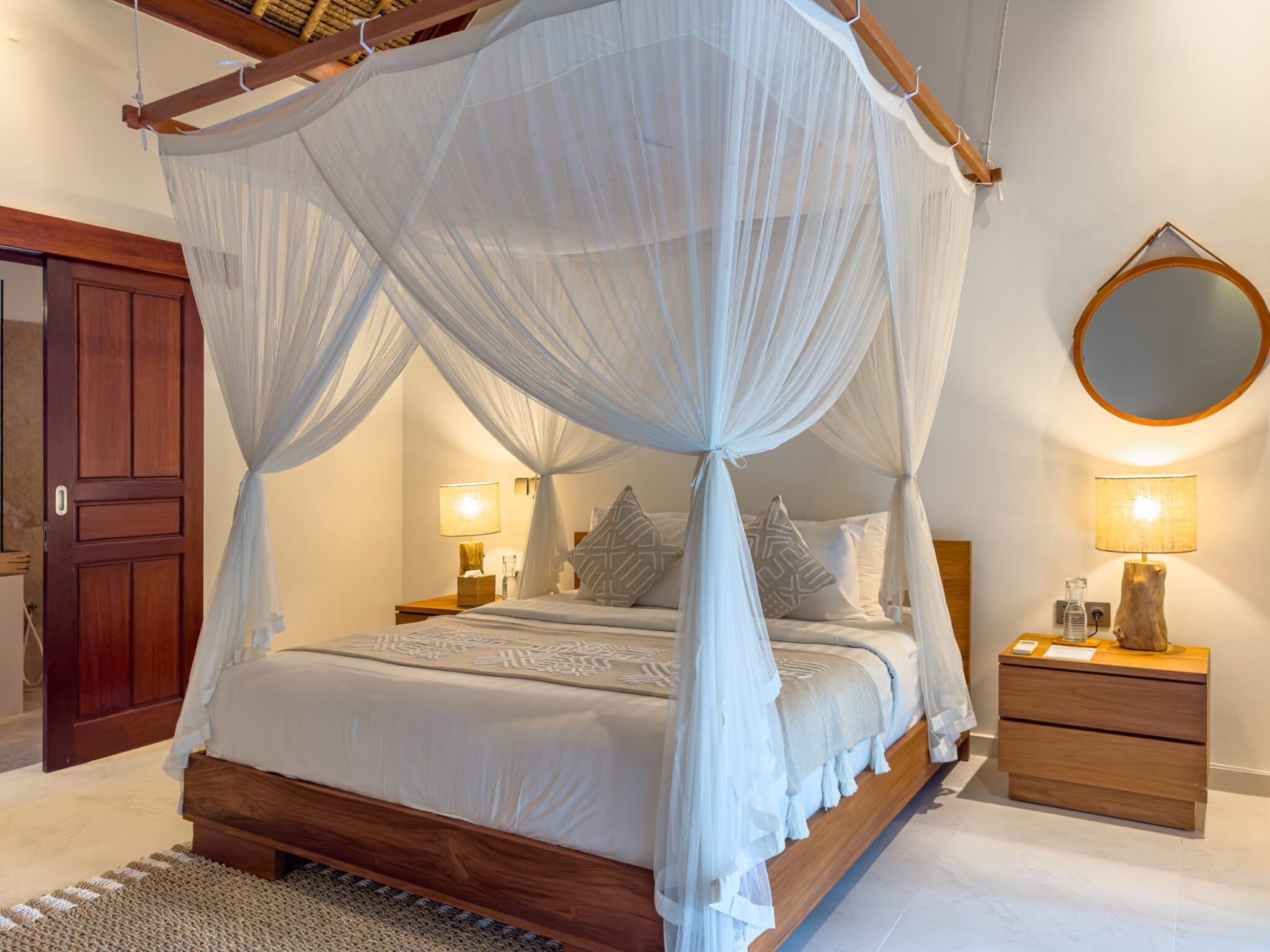 Elegant master bedroom featuring a comfortable king-size bed with tropical decor at Villa Olive Seminyak by Villa Bugis, a top-rated villa Seminyak.