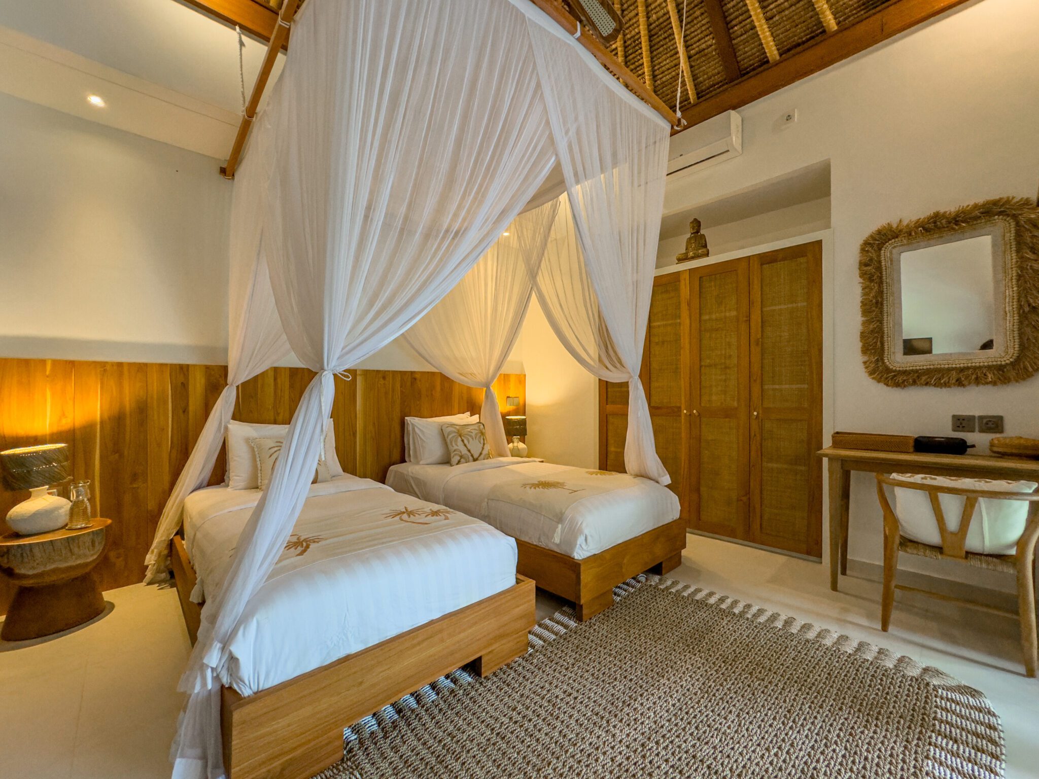 Airy twin bedroom interior setup at Villa Olive Seminyak by Villa Bugis Seminyak villas, equipped with air conditioning and comfortable double single beds.