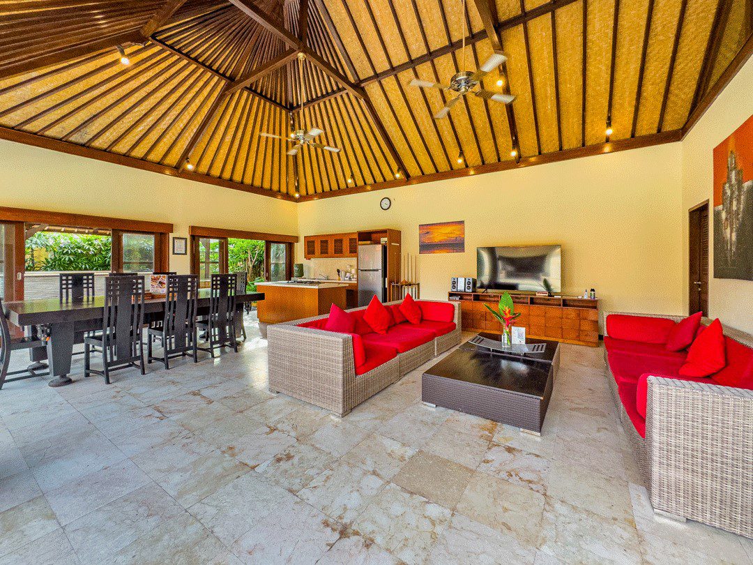 High-ceiling Balinese architectural design of the main living area at Villa Santi Seminyak by Villa Bugis Seminyak villas.