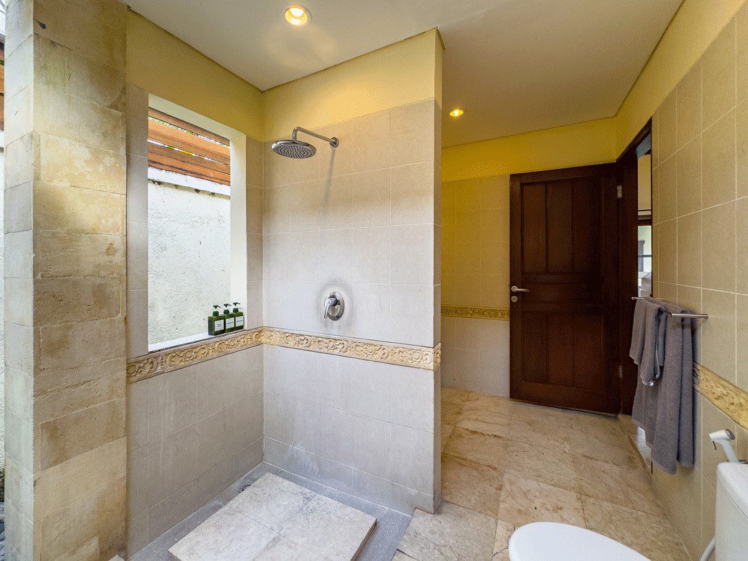 Clean vanity sink and modern shower facilities in bathroom 4 at Villa Santi Seminyak by Villa Bugis Seminyak villas.