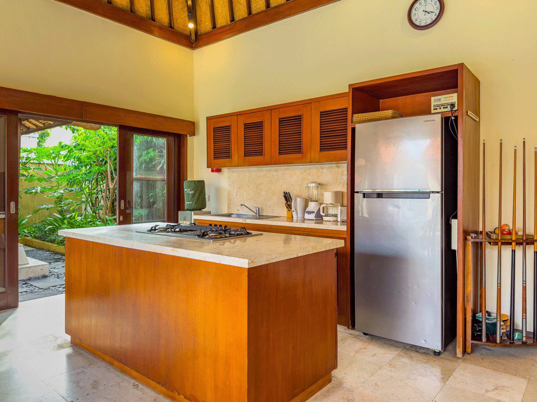 Modern open-concept indoor kitchen fully equipped with high-quality appliances at Villa Santi Seminyak by Villa Bugis villa Seminyak.