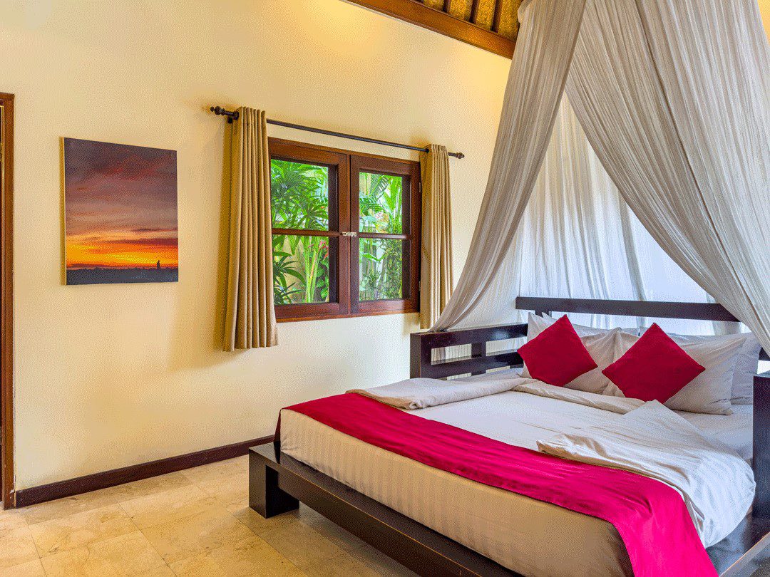 Cozy guest room setup in bedroom 4 at Villa Santi Seminyak by Villa Bugis Seminyak villas, equipped with air conditioning and tropical accents.