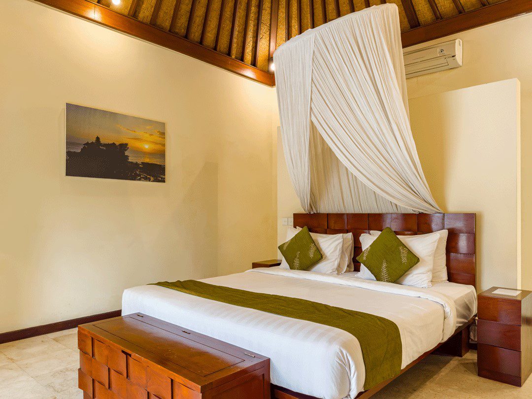 Elegant master bedroom featuring a comfortable king-size bed with tropical decor at Villa Santi Seminyak by Villa Bugis, a top-rated villa Seminyak.