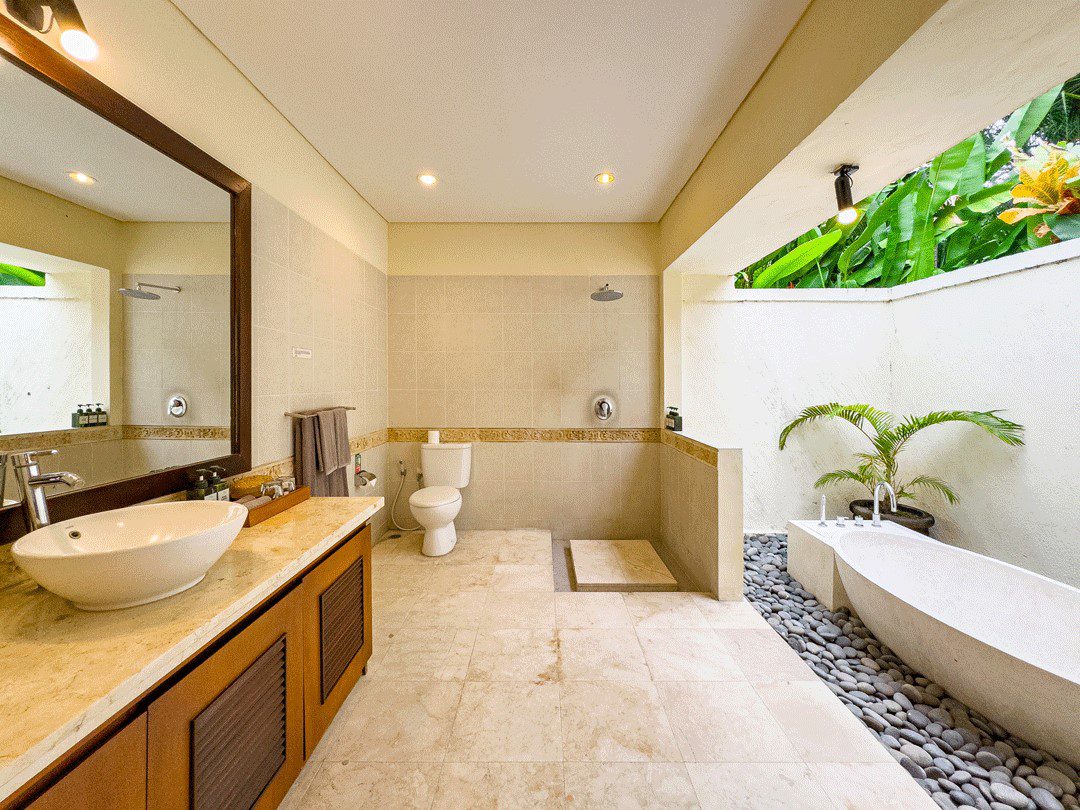 Tropical semi-outdoor ensuite bathroom attached to bedroom 1 at Villa Santi Seminyak by Villa Bugis, offering a unique villa Seminyak experience.
