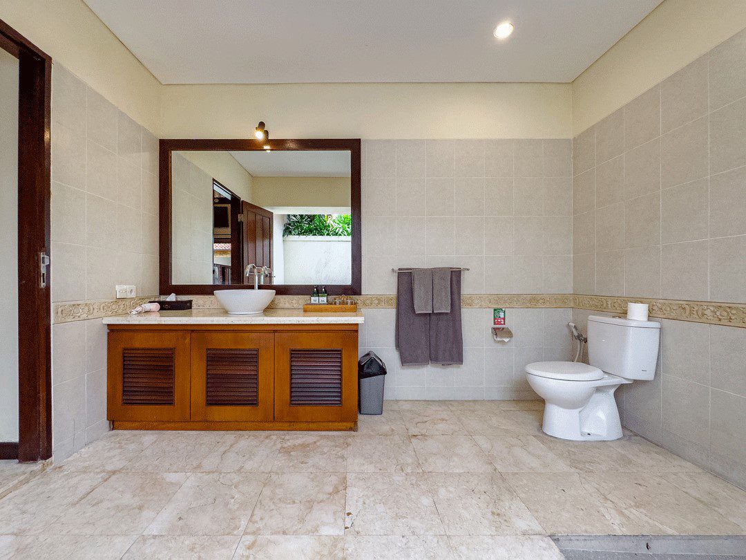 Private open-air ensuite bathroom with modern fixtures attached to bedroom 2 at Villa Santi Seminyak by Villa Bugis Seminyak villas.