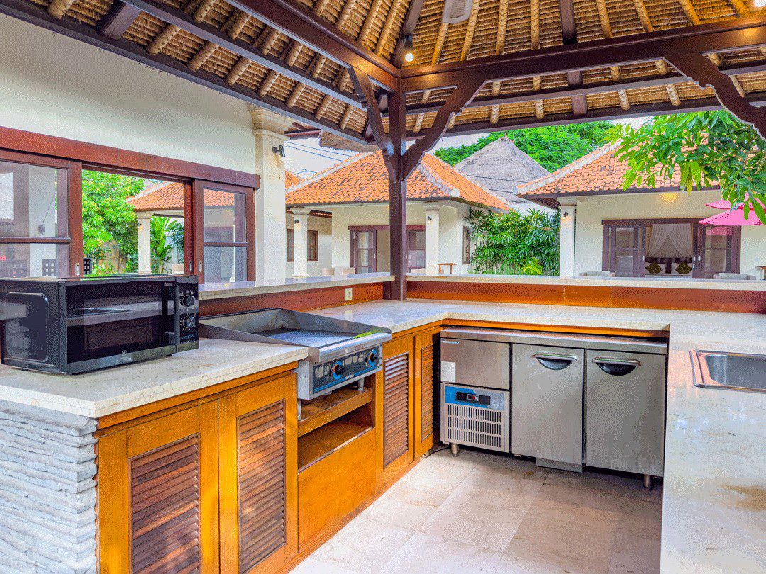 Spacious outdoor kitchen counter and dining preparation area at Villa Santi Seminyak by Villa Bugis, offering self-catering convenience in Seminyak villas.