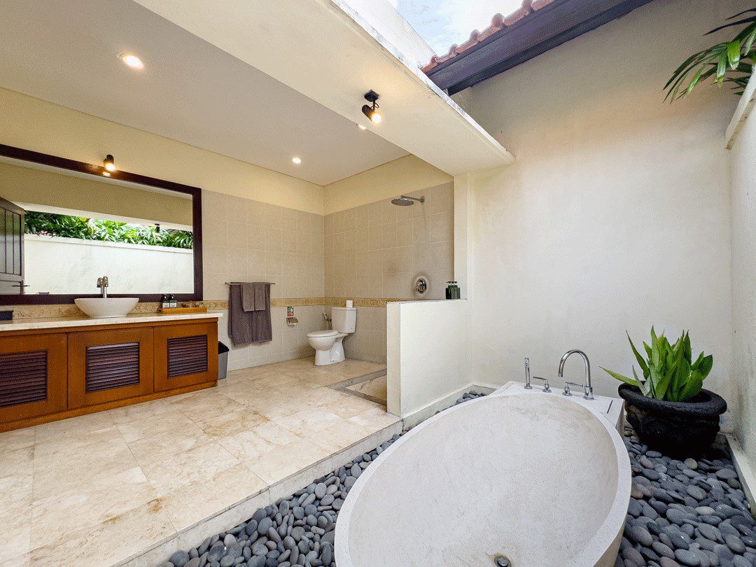 Pristine vanity setup and a soaking bathtub inside the private bathroom of bedroom 2 at Villa Santi Seminyak by Villa Bugis villa Seminyak.