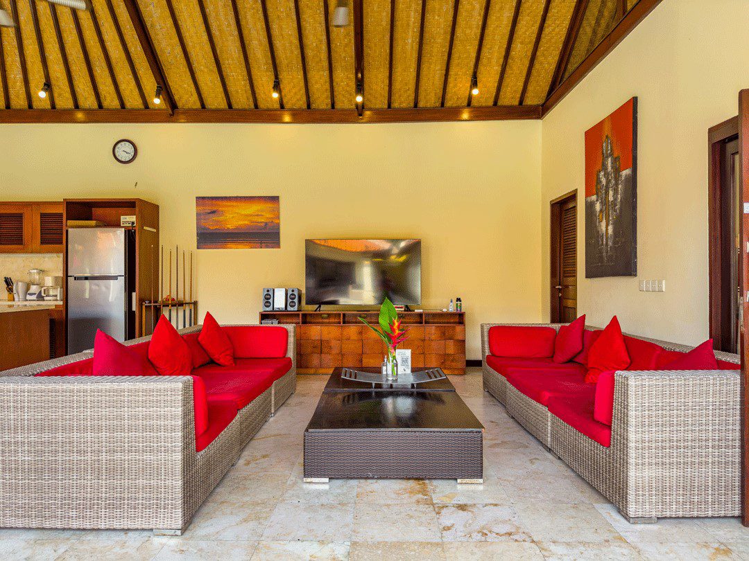 Open-air living room pavilion with plush sofa seating facing the private pool at Villa Santi Seminyak by Villa Bugis villa Seminyak.