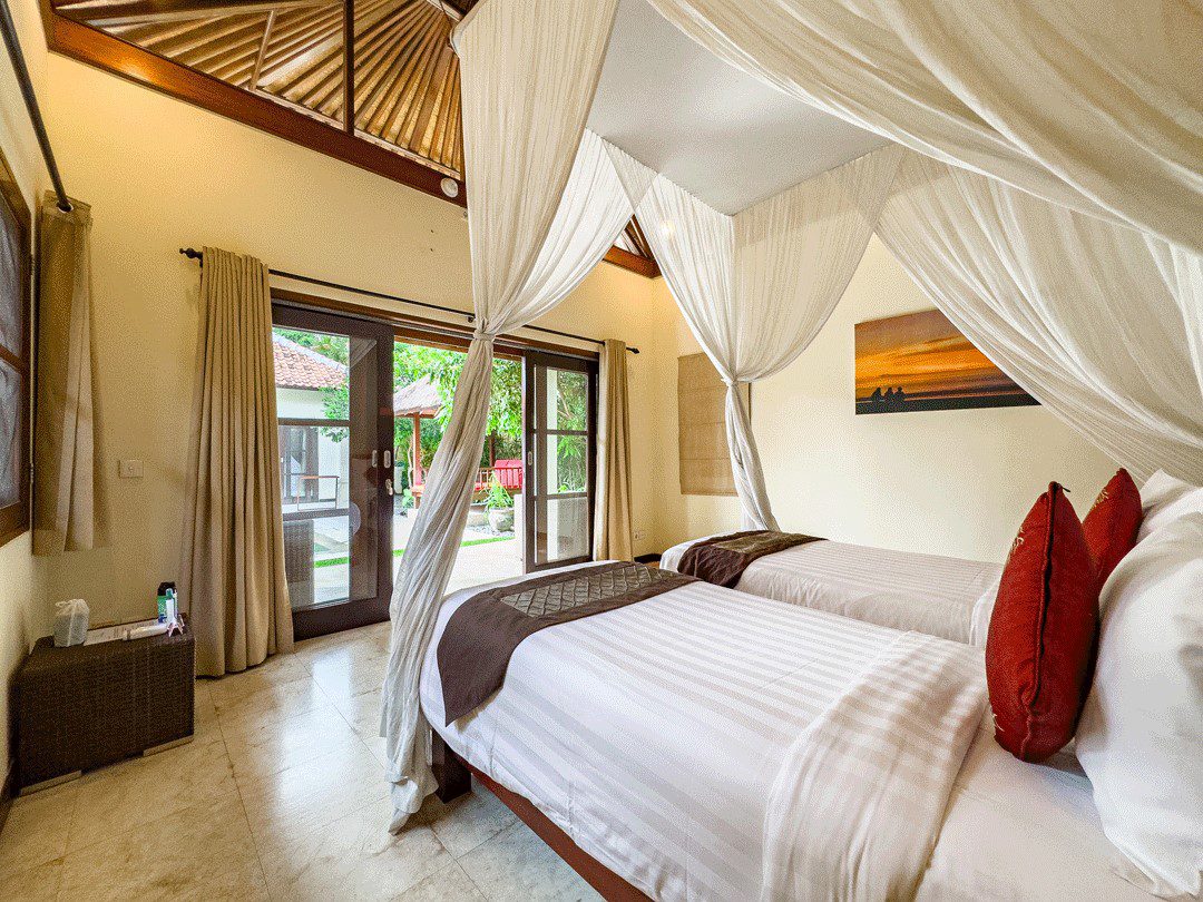 Serene third guest bedroom with premium bedding and a garden view at Villa Santi Seminyak by Villa Bugis, a recommended choice among Seminyak villas.