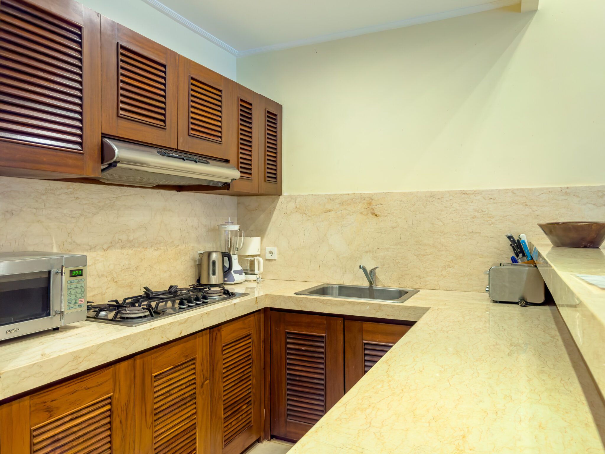 Modern open-concept kitchen fully equipped with high-quality appliances at Villa Saphir Seminyak by Villa Bugis villa Seminyak.