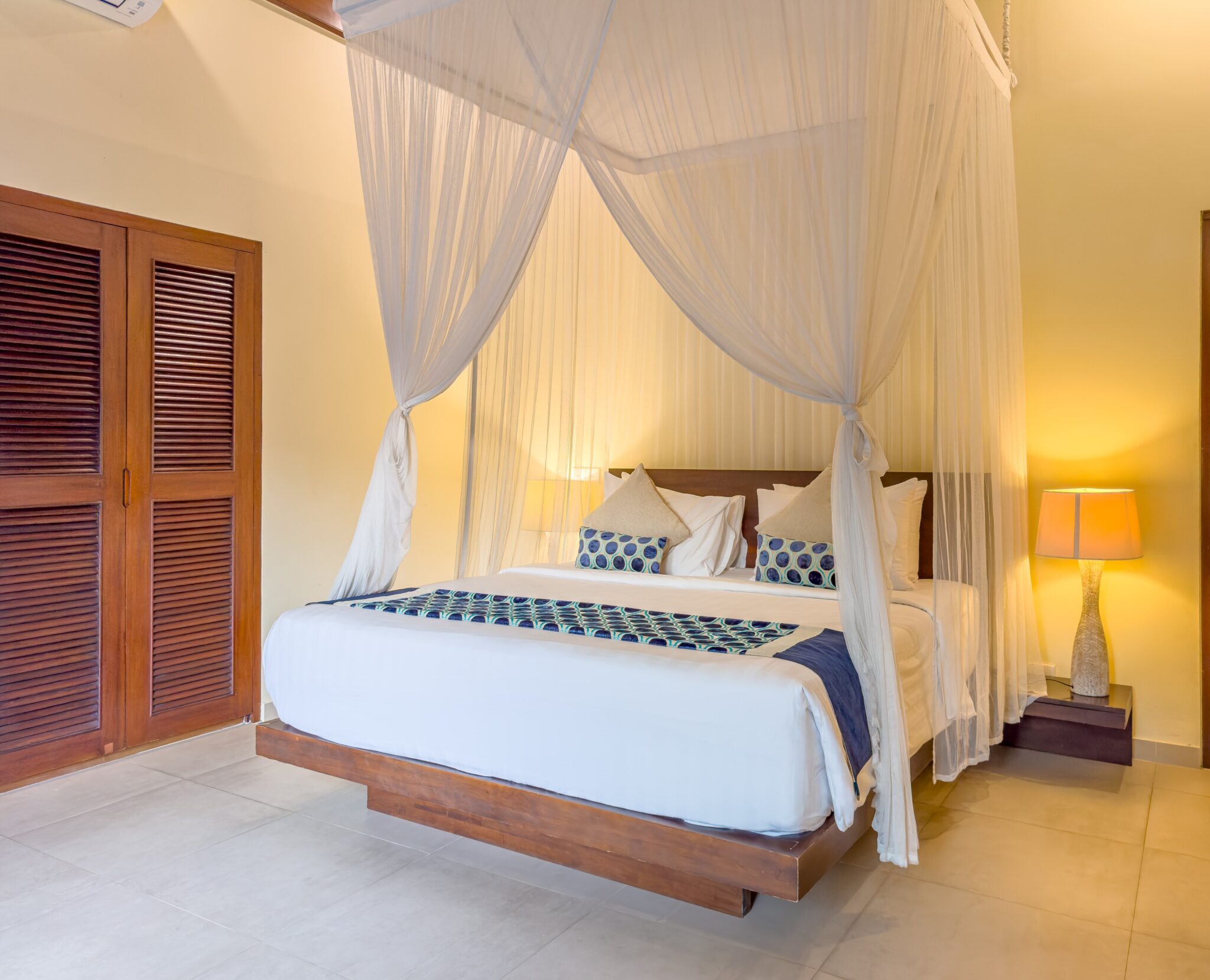 Cozy guest room setup in bedroom 4 at Villa Saphir Seminyak by Villa Bugis Seminyak villas, equipped with air conditioning and tropical accents.