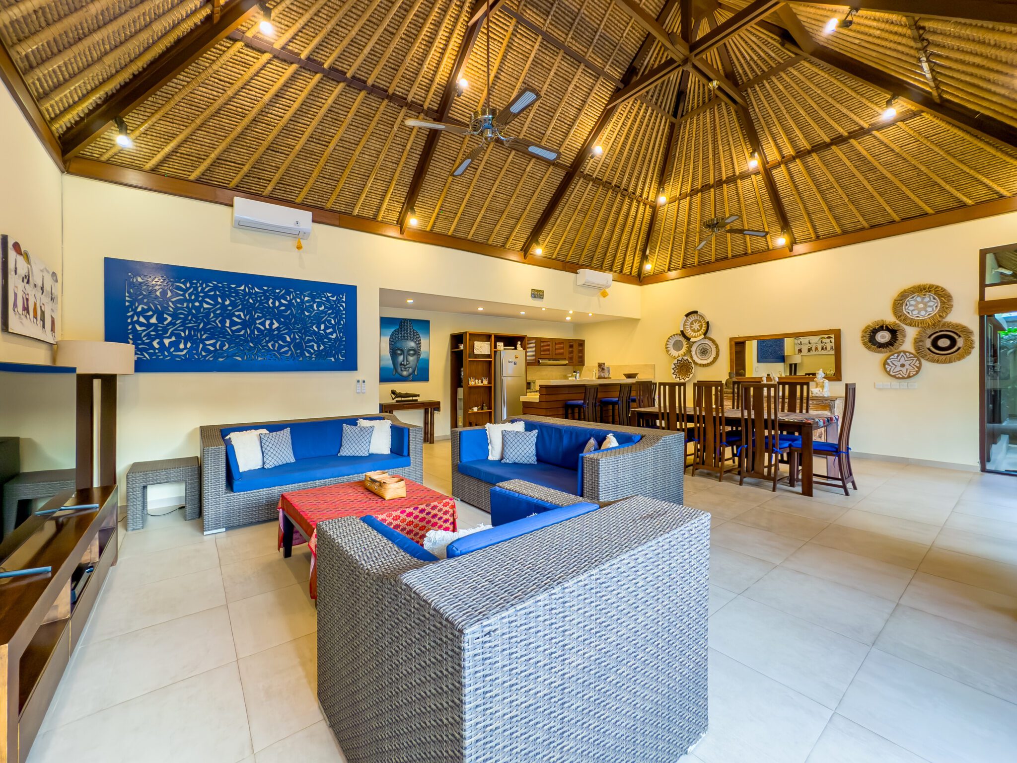 Tropical indoor-outdoor living and dining space overlooking the pool and garden at Villa Saphir Seminyak by Villa Bugis Seminyak villas.