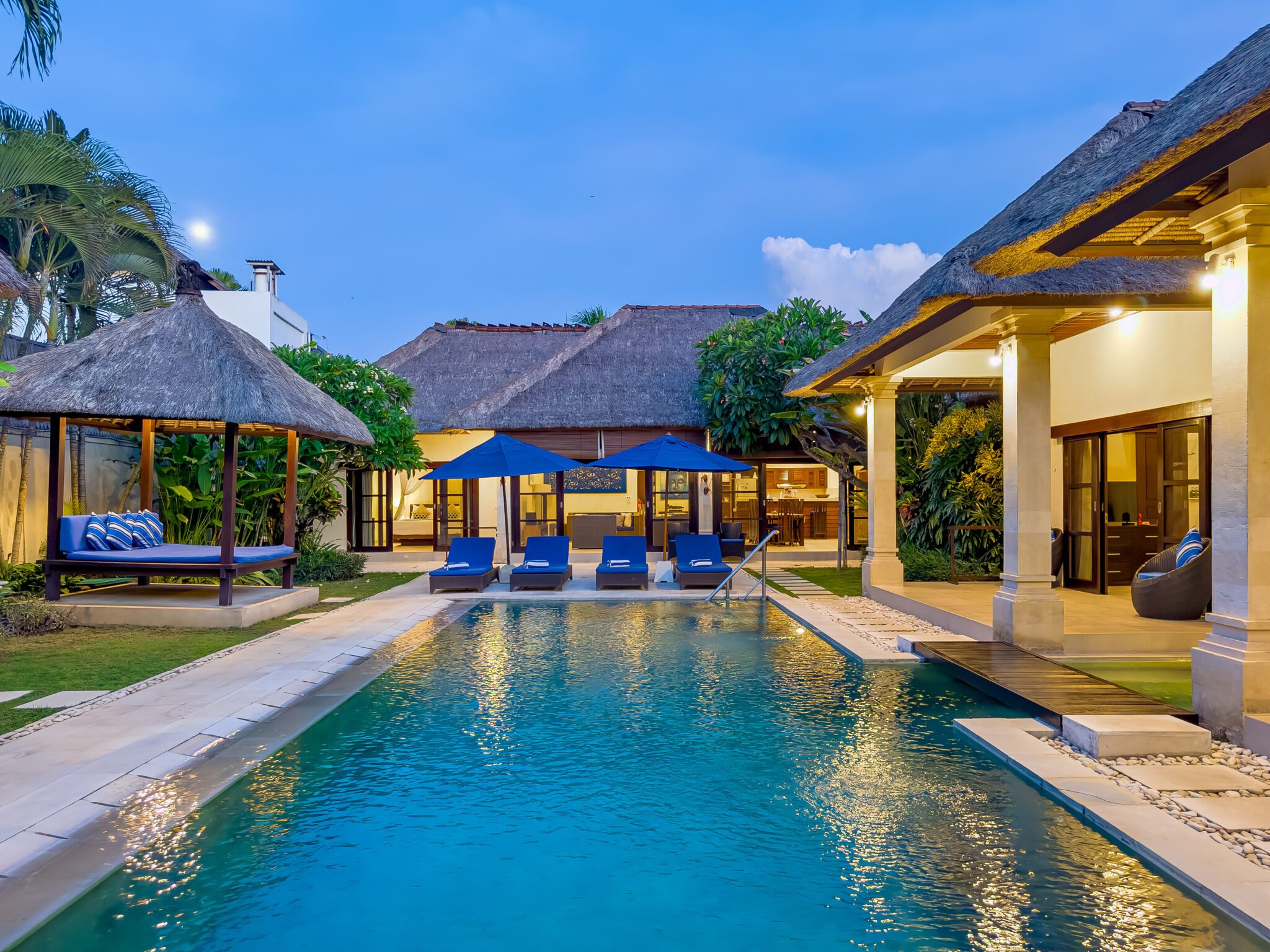 Serene evening ambiance with warm pool lighting reflecting on the water at Villa Saphir Seminyak by Villa Bugis Seminyak villas.