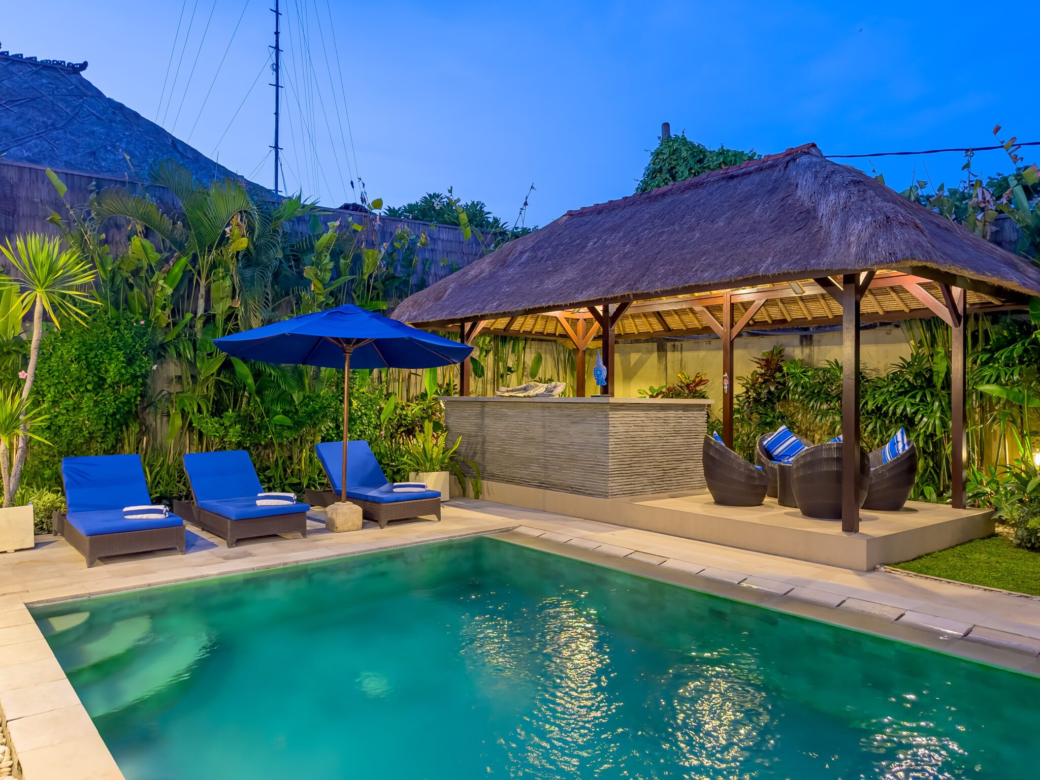 Peaceful nightscape showing the lit swimming pool and garden gazebo at Villa Saphir Seminyak by Villa Bugis Seminyak villas.