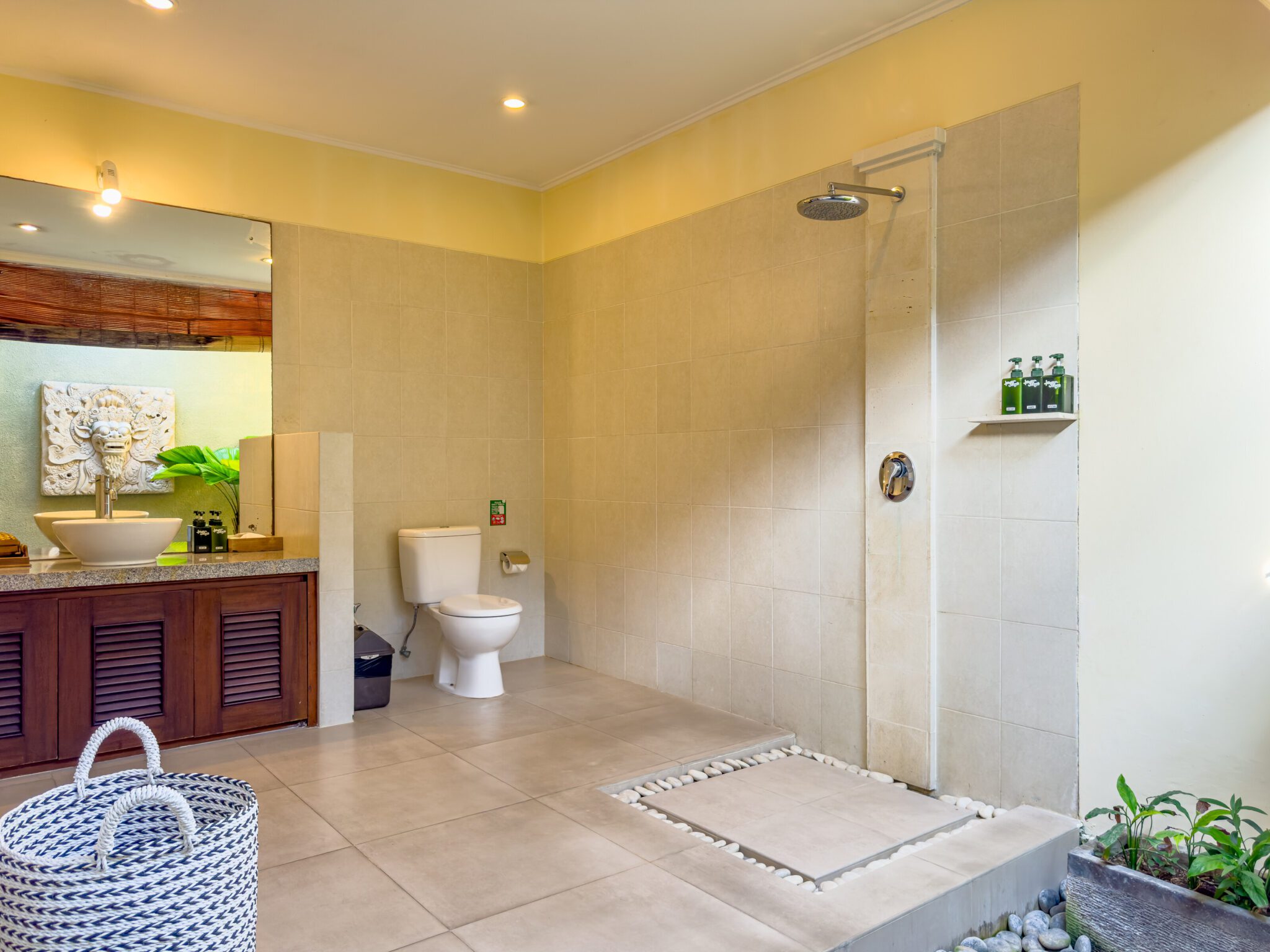 Tropical semi-outdoor ensuite bathroom attached to bedroom 1 at Villa Saphir Seminyak by Villa Bugis, offering a unique villa Seminyak experience.