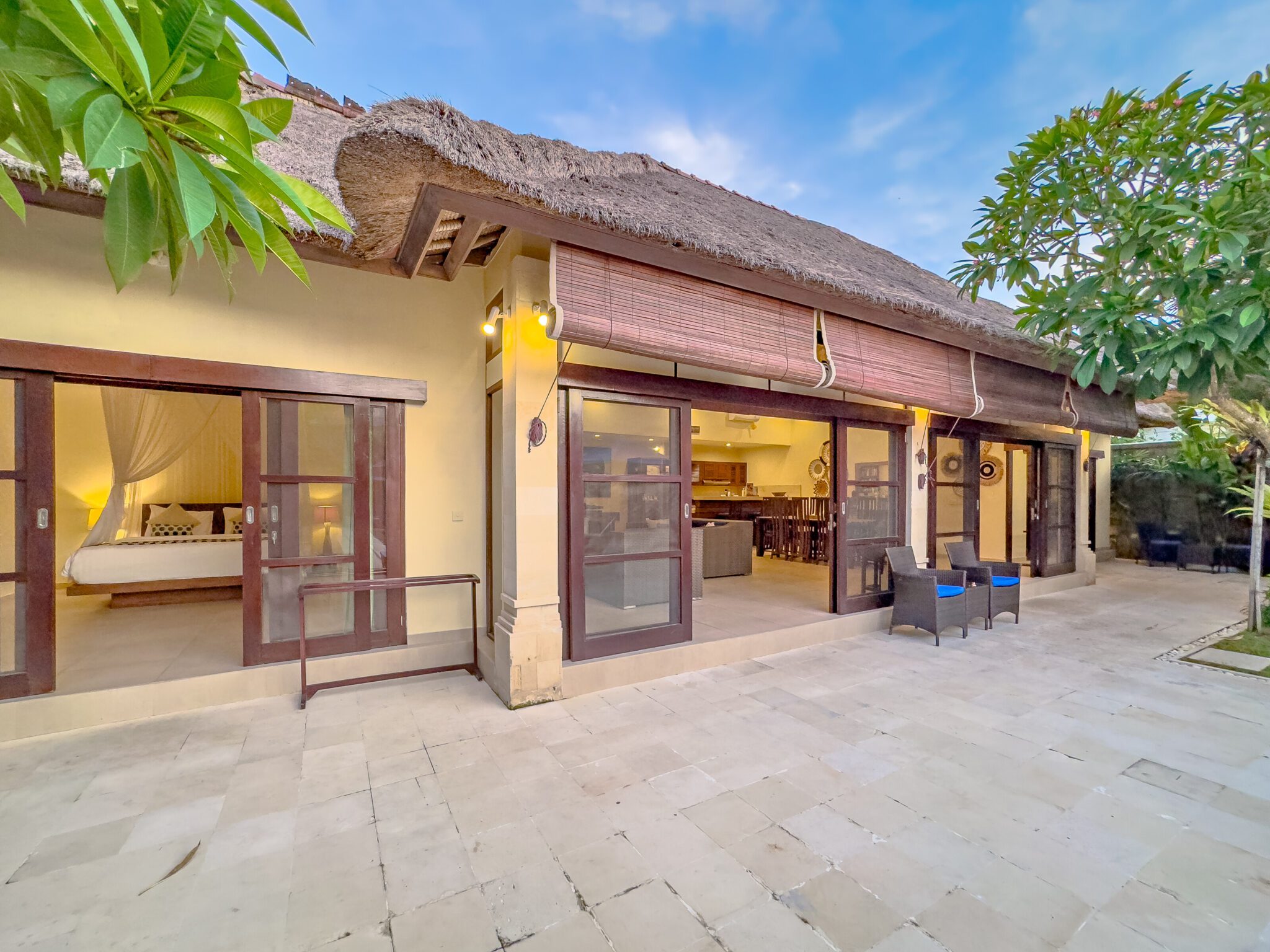 Open-air living room pavilion with plush sofa seating facing the private pool at Villa Saphir Seminyak by Villa Bugis villa Seminyak.
