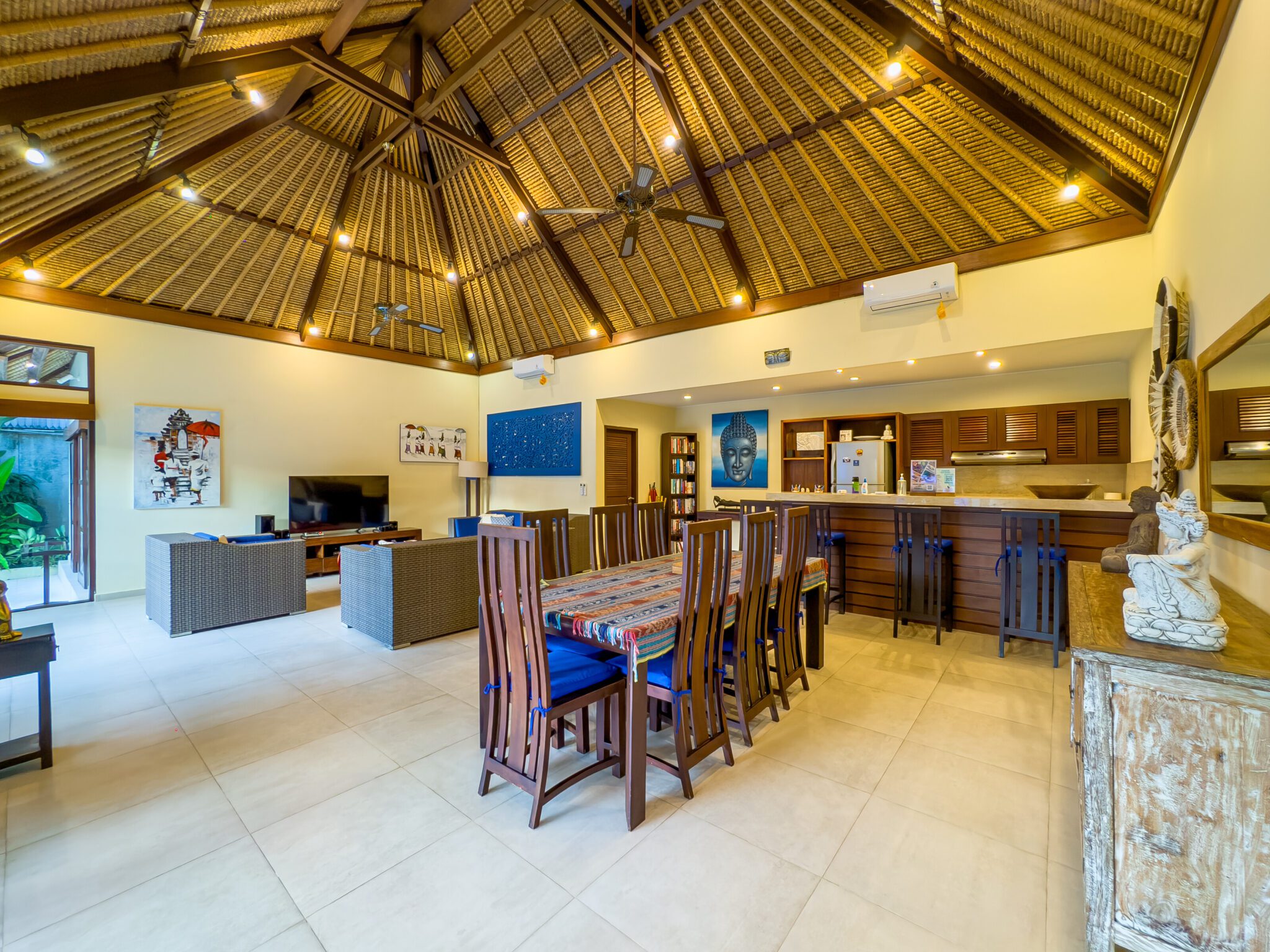 High-ceiling Balinese architectural design of the main living area at Villa Saphir Seminyak by Villa Bugis Seminyak villas.