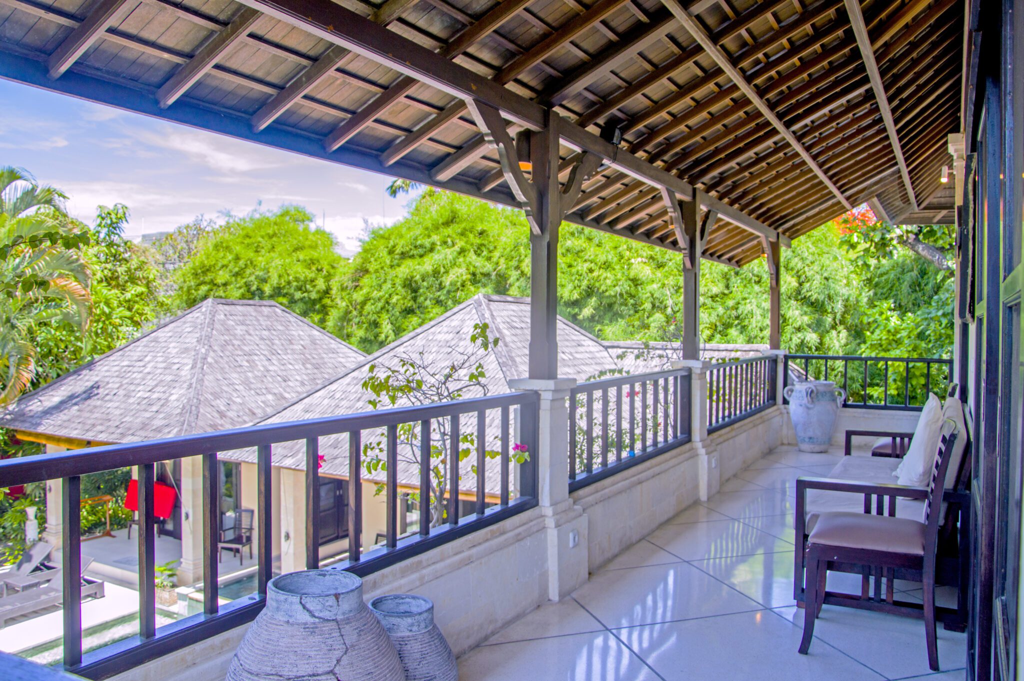 Private front balcony with comfortable seating attached to bedroom 5 at Villa Tresna Seminyak by Villa Bugis villa Seminyak.