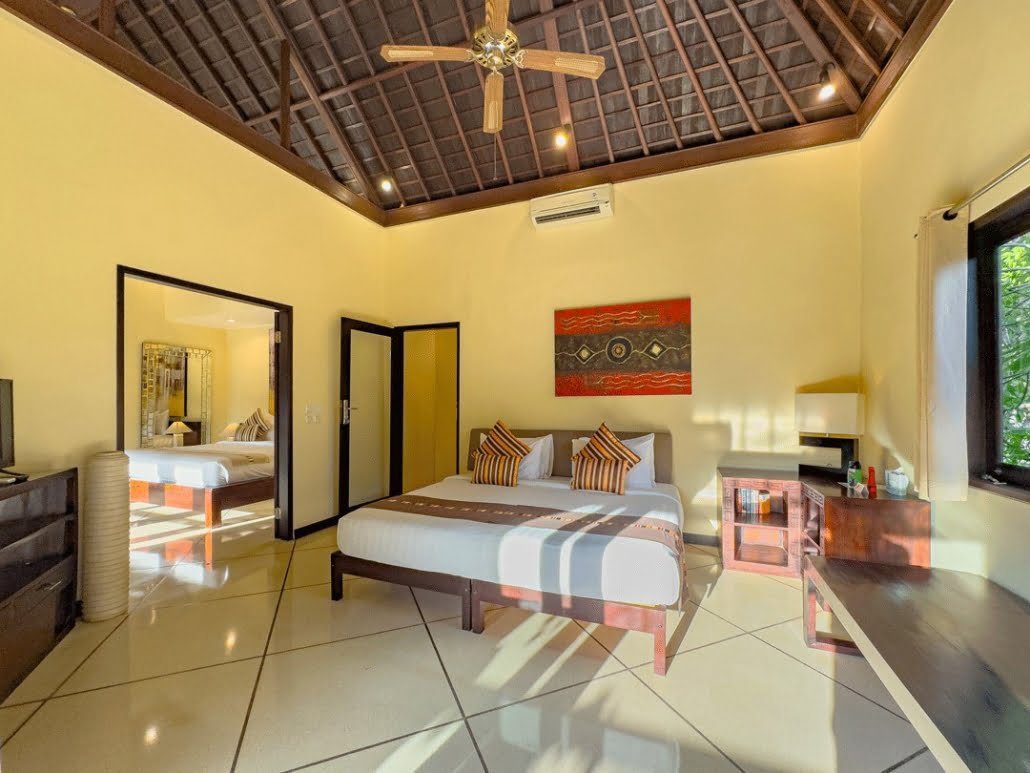 Elegant interior design and warm lighting in bedroom 5 at Villa Tresna Seminyak by Villa Bugis Seminyak villas.