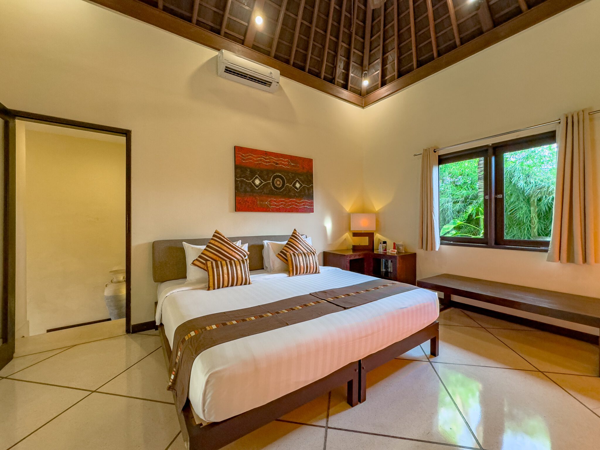 Luxurious fifth bedroom suite with a king-size bed at Villa Tresna Seminyak by Villa Bugis, a standout among large villa Seminyak options.