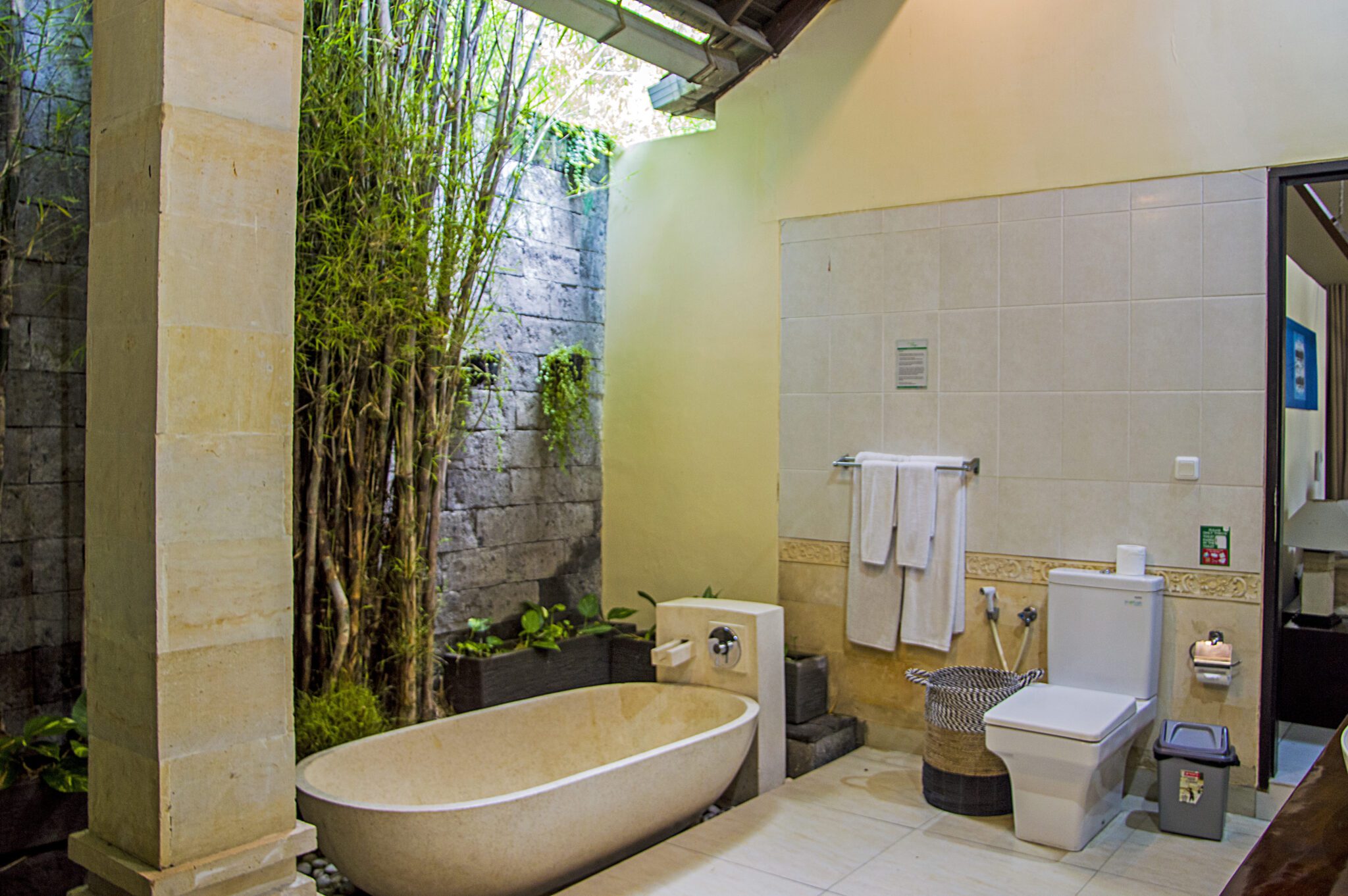 Clean vanity sink, modern shower facilities, and a soaking bathtub in bathroom 4 at Villa Tresna Seminyak by Villa Bugis Seminyak villas.