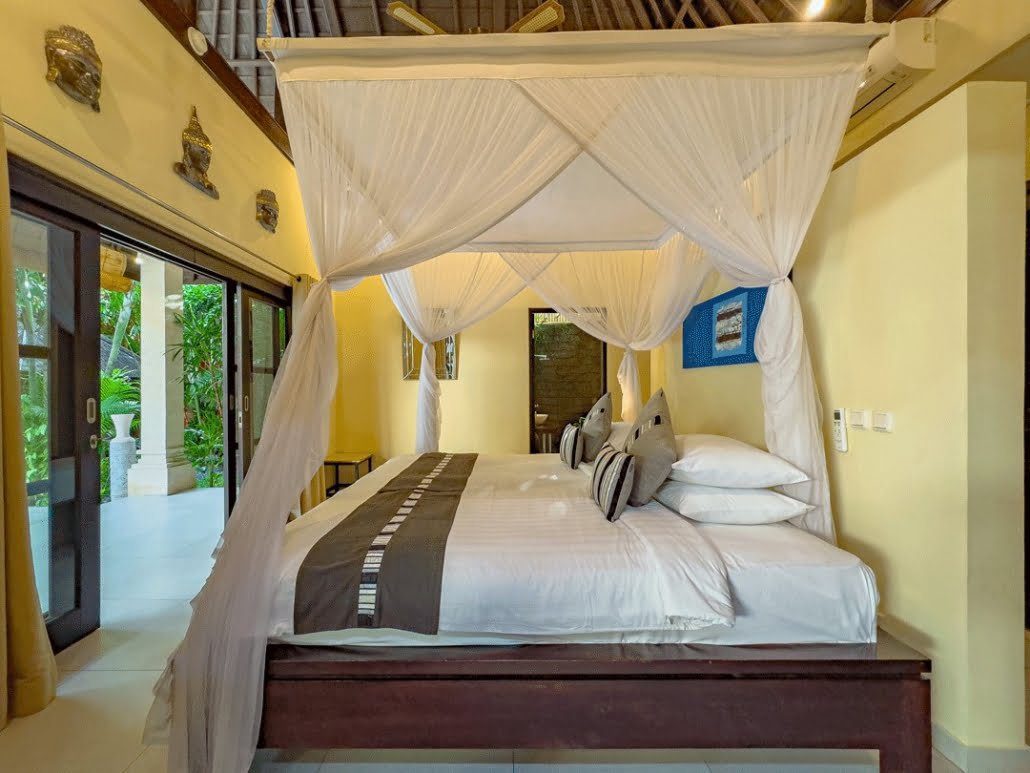 Comfortable fourth bedroom with garden views at Villa Tresna Seminyak by Villa Bugis, offering quiet privacy in a spacious 5-bedroom villa Seminyak.