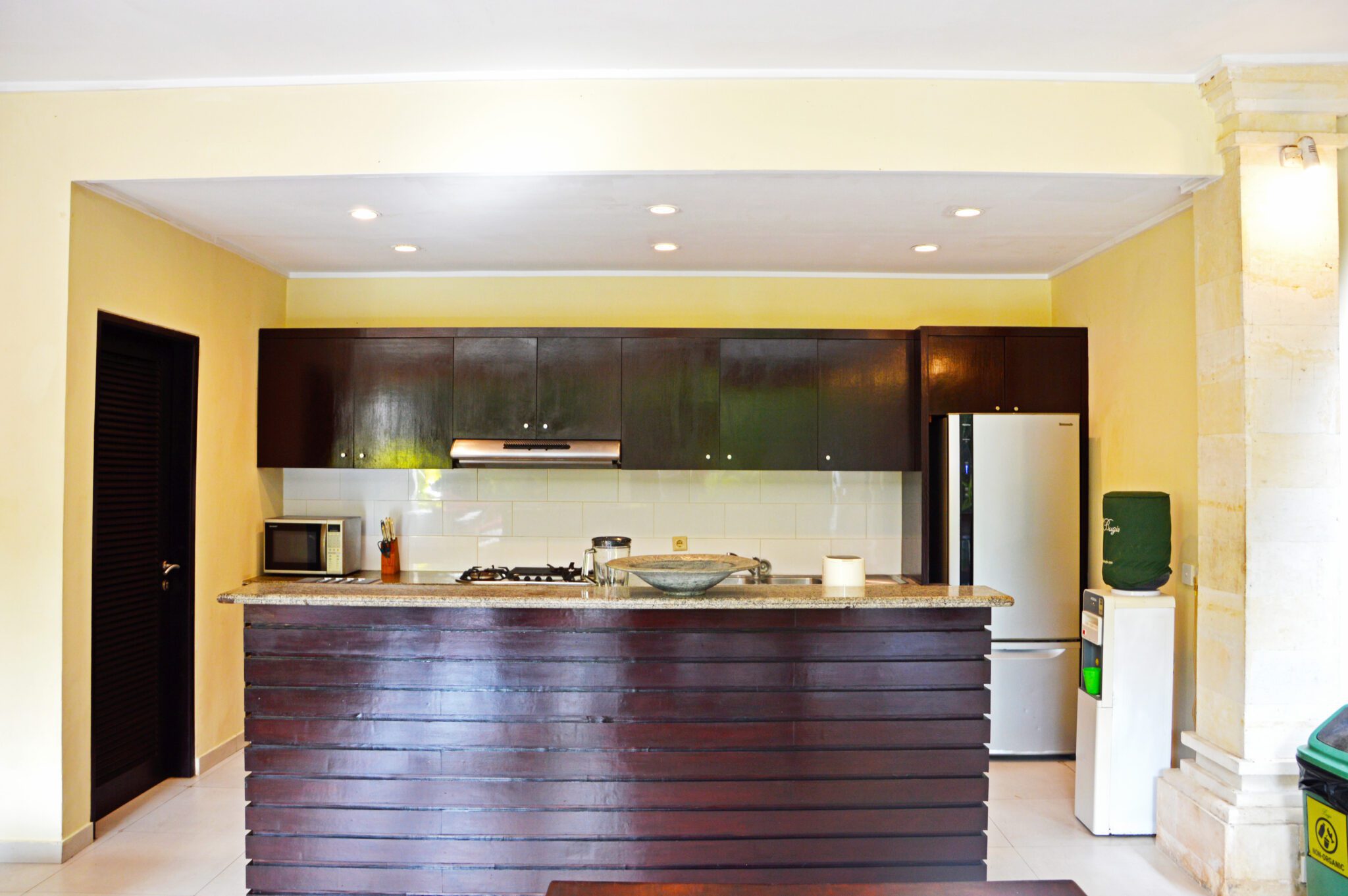 Modern open-concept kitchen fully equipped with high-quality appliances at Villa Tresna Seminyak by Villa Bugis villa Seminyak.