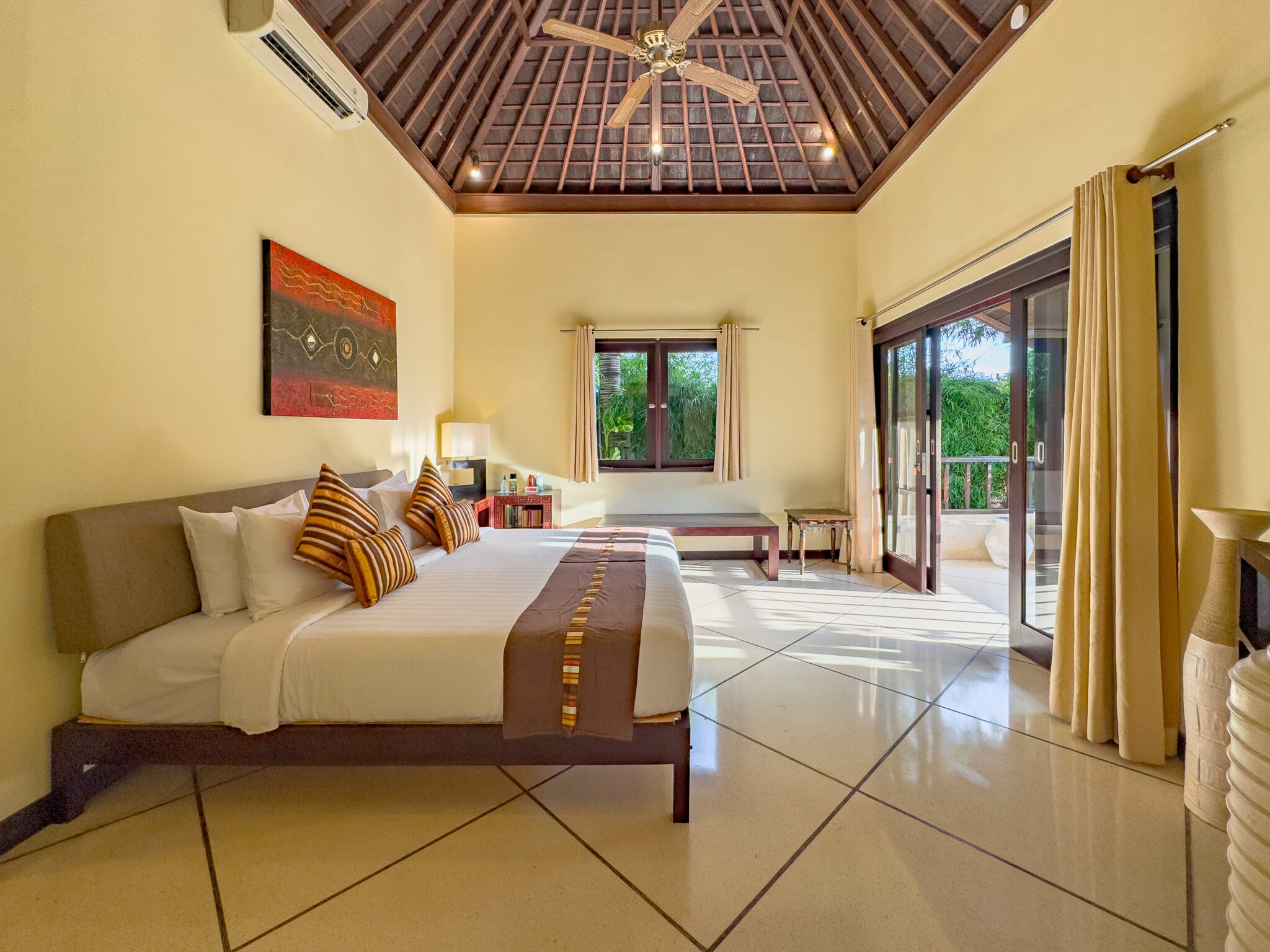 Spacious seating area and tropical furnishings inside bedroom 5 at Villa Tresna Seminyak by Villa Bugis villa Seminyak.