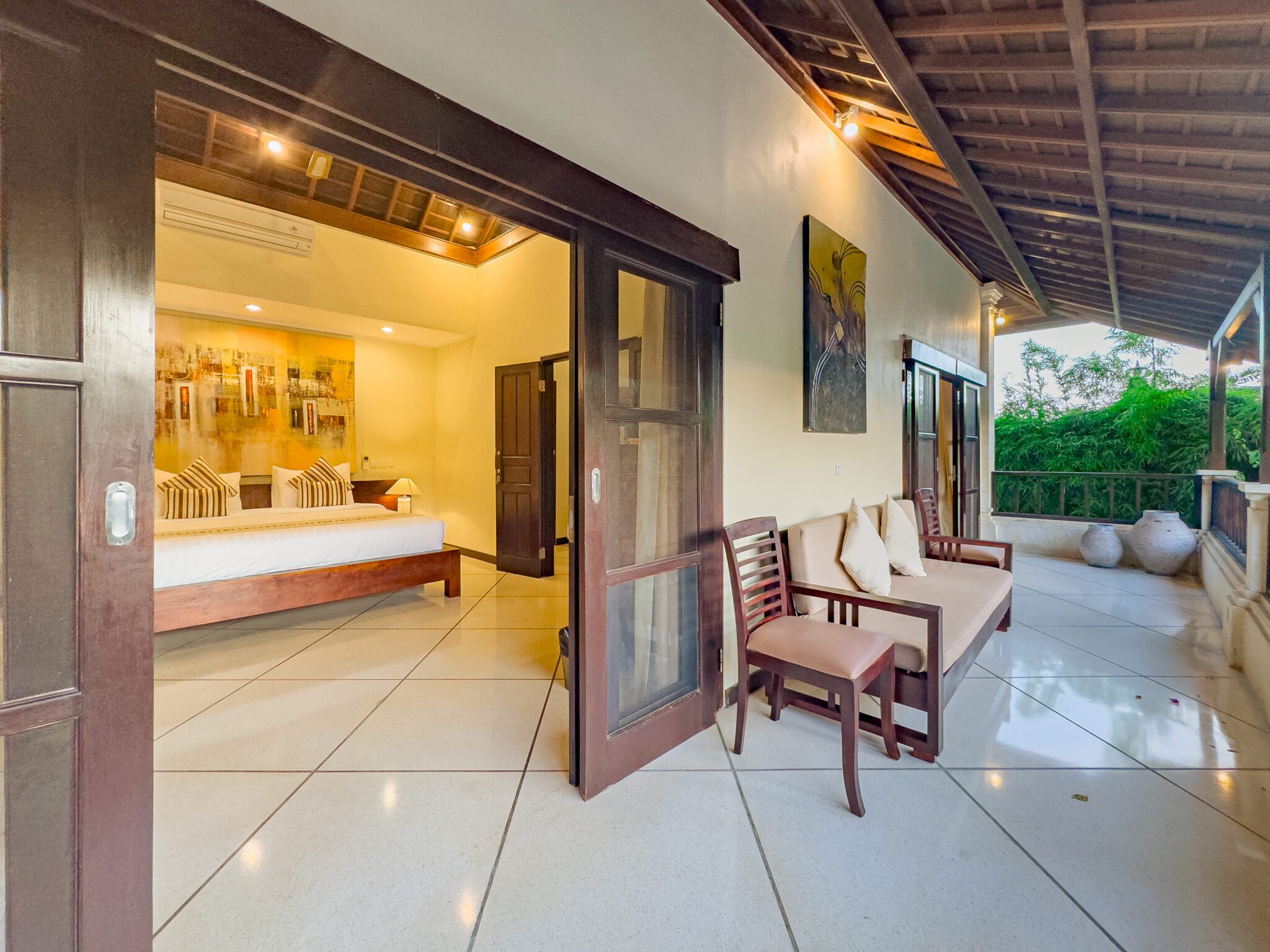 Private upper-level balcony connected to bedroom 1 overlooking the garden at Villa Tresna Seminyak by Villa Bugis Seminyak villas.