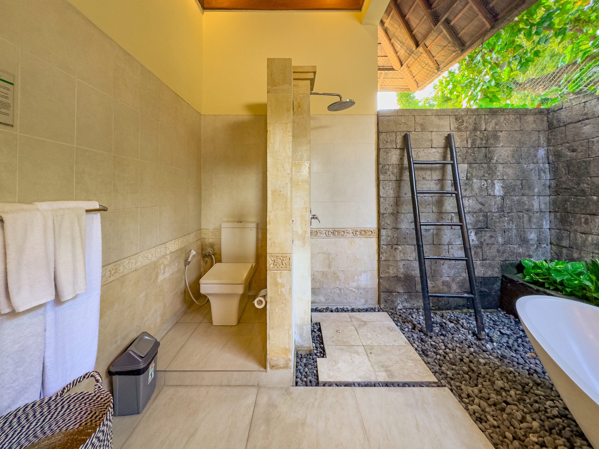 Clean modern vanity, stone basin, and refreshing shower area in the master bathroom at Villa Tresna Seminyak by Villa Bugis Seminyak villas.
