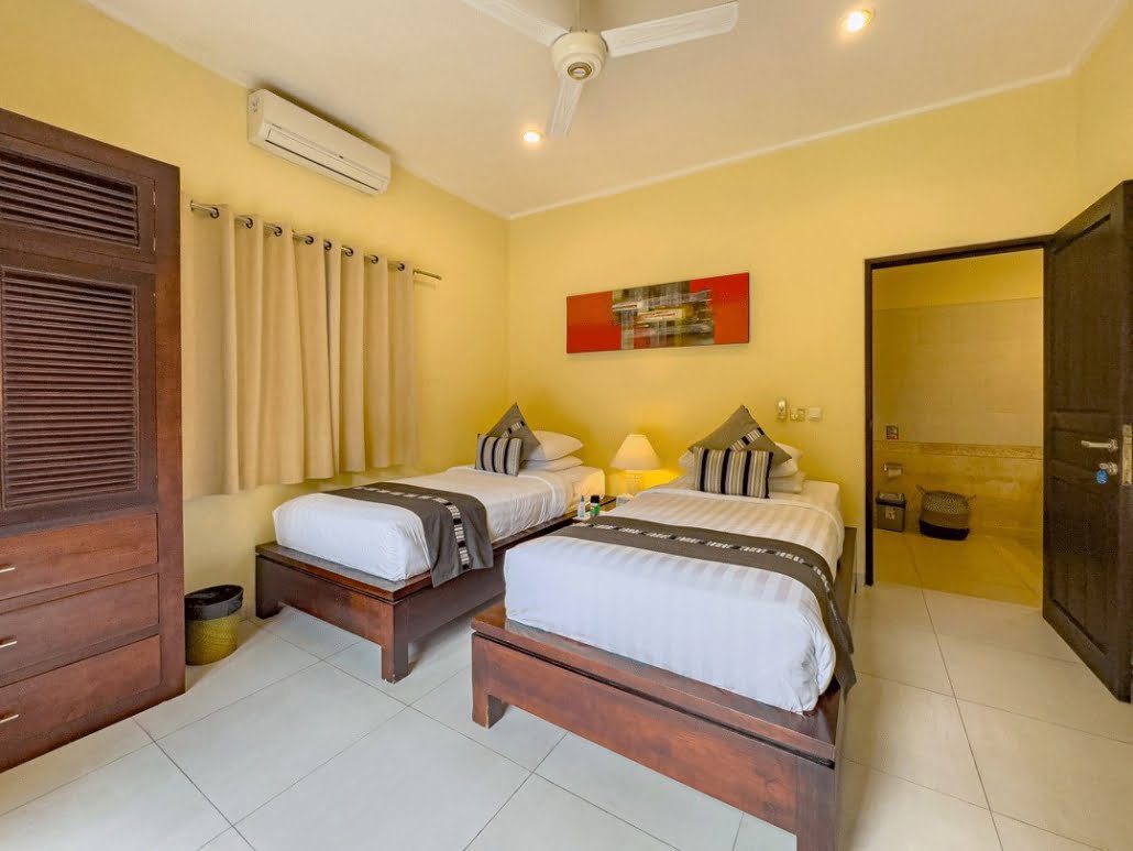 Guest bedroom 2 featuring neatly arranged twin beds at Villa Tresna Seminyak by Villa Bugis, offering flexible arrangements in a 5-bedroom villa Seminyak.